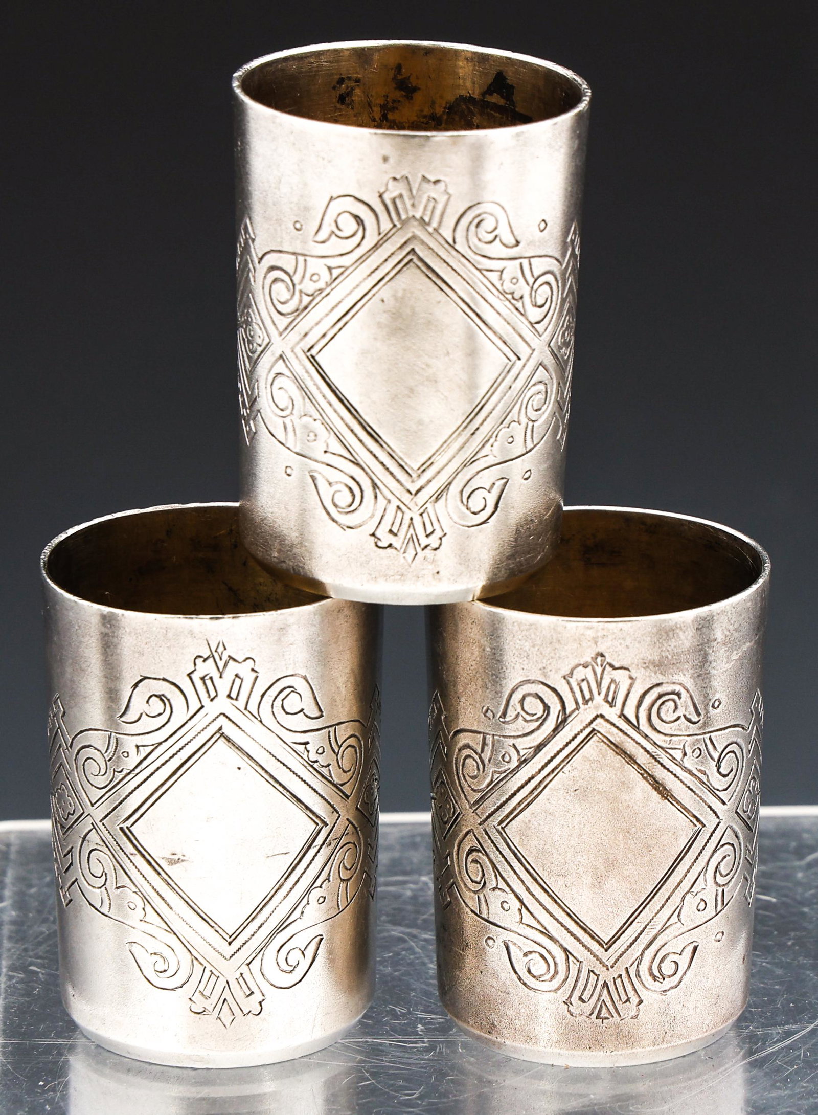 RUSSIAN 84 SILVER ETCHED VODKA CUPS: RUSSIAN 84 SILVER ETCHED VODKA CUPS Lot of three Russian 84 zolotnik (.875 fineness) silver vodka cups, decorated with etched design. Marked on underside. Size: 1 7/8 x 1 1/4" Weight: 101.4 grams tota