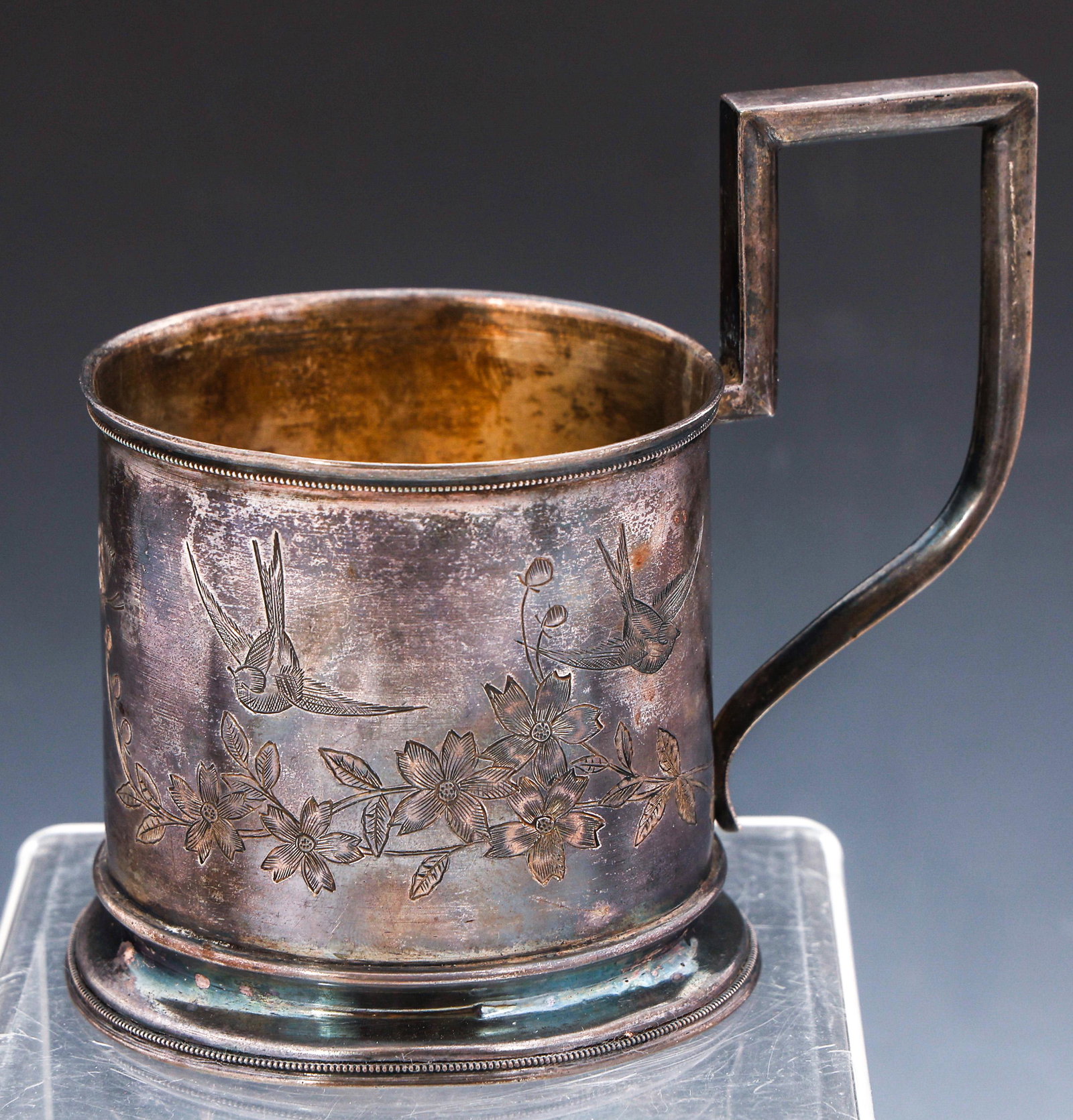 RUSSIAN 84 SILVER TEA GLASS HOLDER: RUSSIAN 84 SILVER TEA GLASS HOLDER Russian 84 zolotinik (.875 fineness) silver tea glass holder, decorated with etched floral design of sparrows and butterfly. Marked on underside and near handle, cir