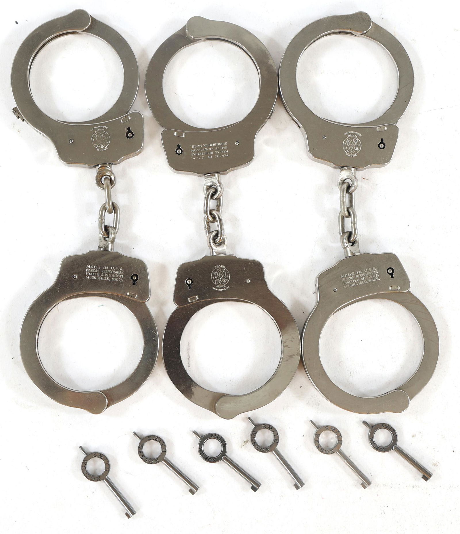 SMITH & WESSON MODEL 90 HANDCUFFS: SMITH & WESSON MODEL 90 HANDCUFFS Lot of three Smith & Wesson handcuffs with original boxes and keys. Model 90. Measurements: 3.25 x 4.75 x 1" box
