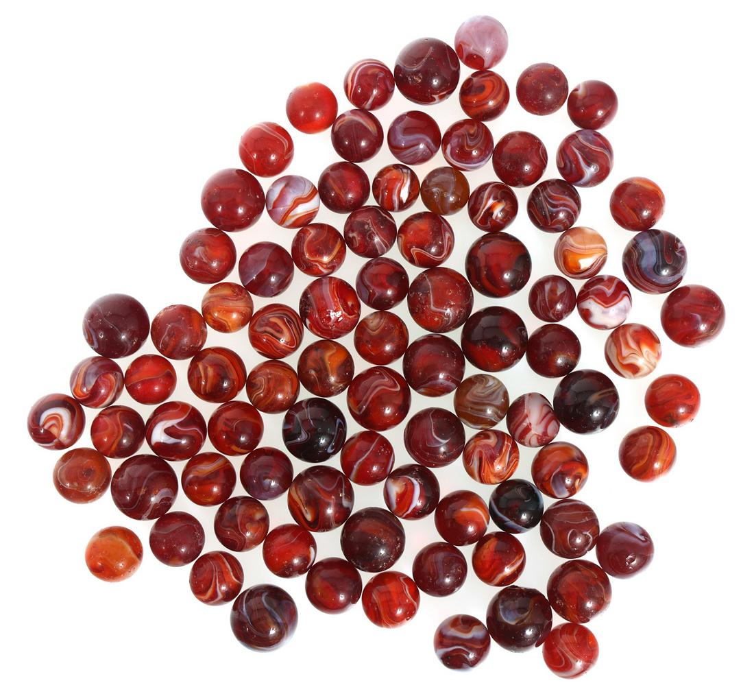EARLY 20th C. RED SLAG GLASS MARBLES: EARLY 20th C. RED SLAG GLASS MARBLES 80+ red slag glass marbles, early 20th century.