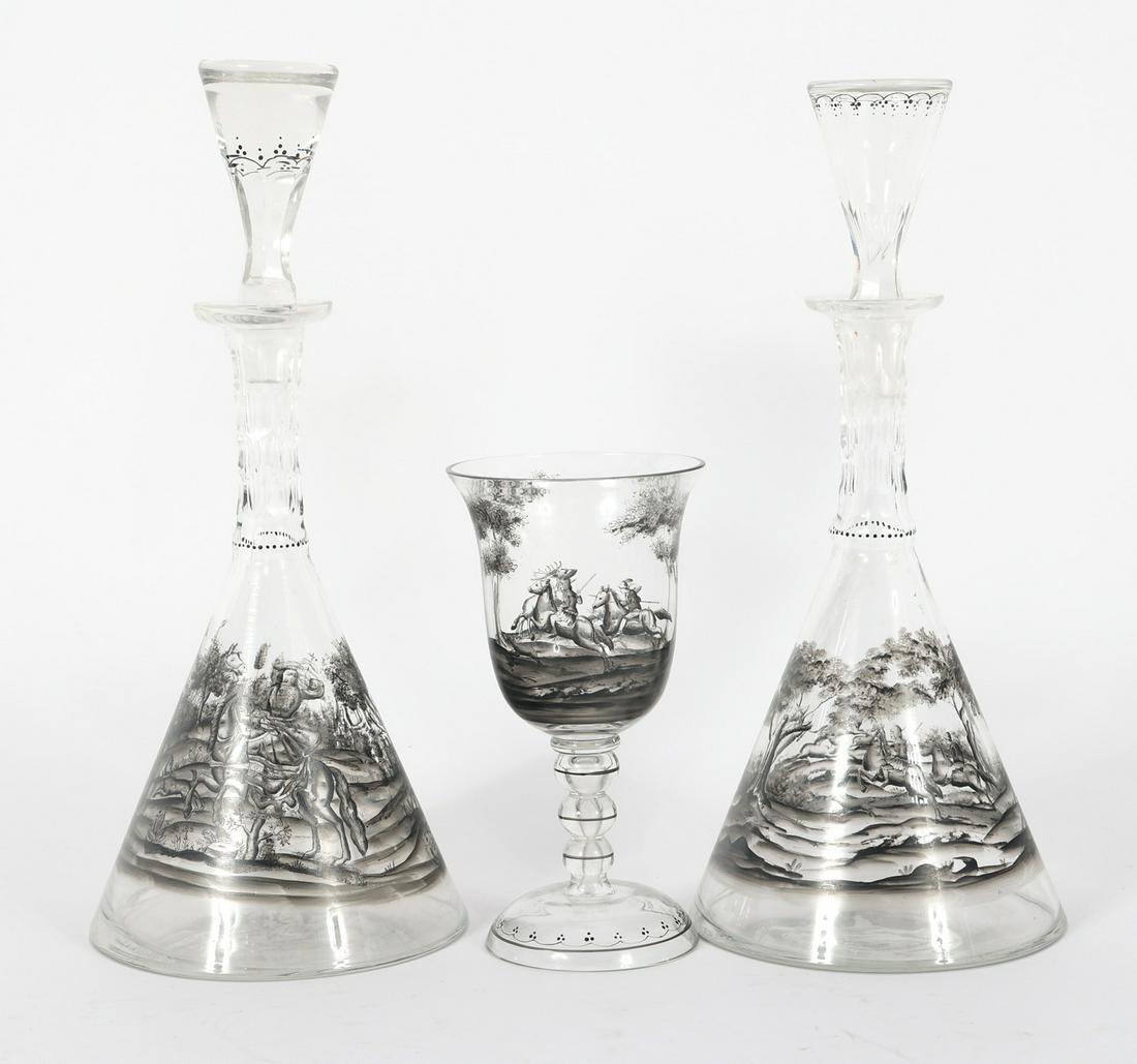 JOSEF LENHARDT SCHWARZLOT GLASS GOBLET & DECANTERS: JOSEF LENHARDT SCHWARZLOT GLASS GOBLET & DECANTERS Josef Lenhardt of Steinschönau, schwarzlot (black enamel painting style) glass drinkware, includes: Goblet, 7" (2) Decanters, 12.5"