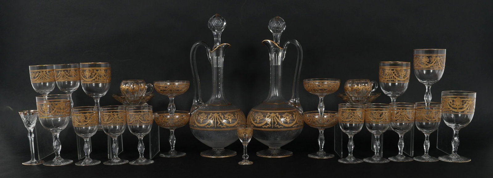 ST. LOUIS CRYSTAL SERVICE PIECES - PITCHERS & GLASSES: ST. LOUIS CRYSTAL SERVICE PIECES - PITCHERS & GLASSES St. Louis style crystal service pieces, includes: (2) Decanter/pitchers - 14" (5) Water glasses - 6.5" (9) Wine glasses - 5.25" (4) Champagne glas