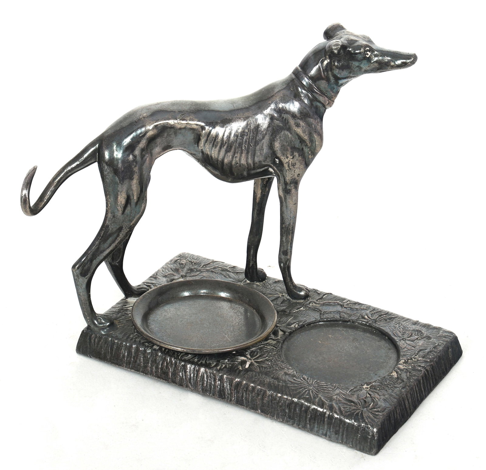 KRONHEIMER & OLDENBUSCH SILVERPLATED WHIPPET ASHTRAY: KRONHEIMER & OLDENBUSCH SILVERPLATED WHIPPET ASHTRAY Kronheimer & Oldenbusch silverplated ashtray with a whippet dog and small attached tray for ashes. Marked to the underside. Size: 6.