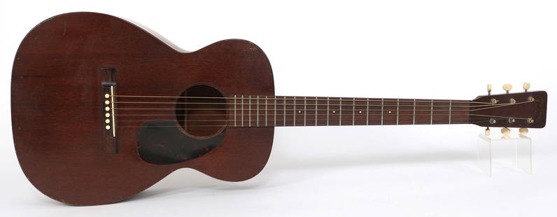 1958 C.F. MARTIN 0-15 ACOUSTIC NATURAL FINISH GUITAR: 1958 C.F. MARTIN 0-15 ACOUSTIC NATURAL FINISH GUITAR  1958 C.F. Martin 0-15 acoustic natural finish guitar with tortoise-pattern pick-guard and six strings. Includes unmarked case. Size: 13.5 x 39"