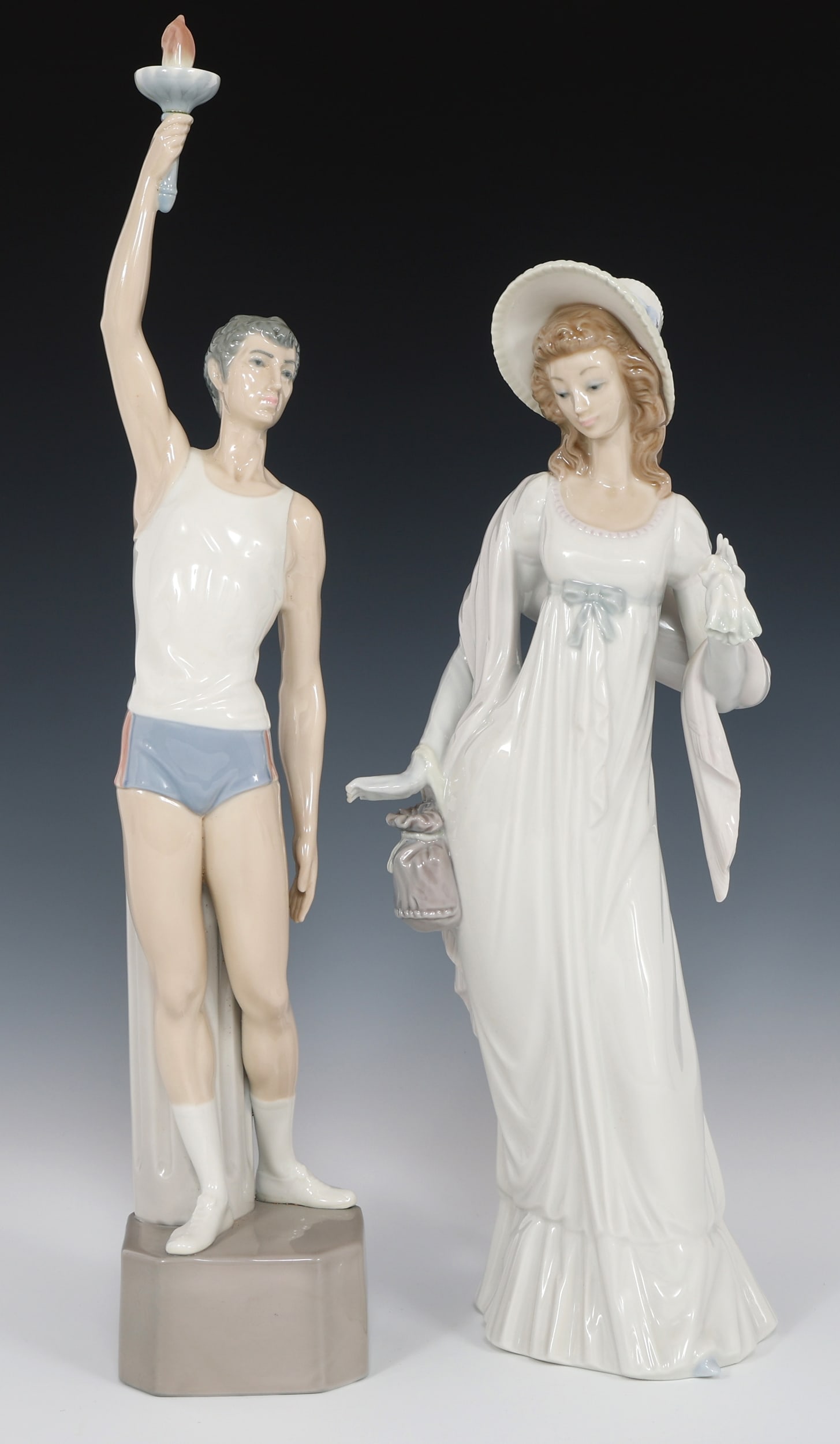 LLADRO TORCH BEARER & DAINTY LADY PORCELAIN FIGURINES: LLADRO TORCH BEARER & DAINTY LADY PORCELAIN FIGURINES Two Lladro porcelain figurines including: "Torch Bearer" #4940, 17" "Dainty Lady" #4964, 14" Size: Varied
