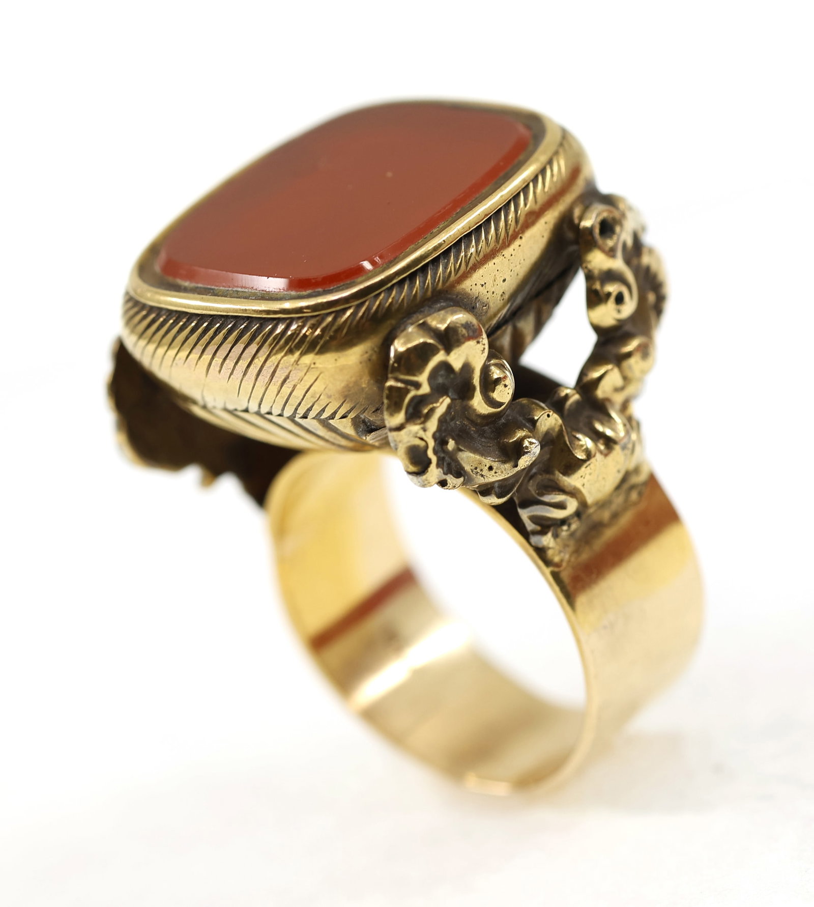 VICTORIAN GOLD-FILLED POCKET WEIGHT CONVERTED TO RING: VICTORIAN GOLD-FILLED POCKET WEIGHT CONVERTED TO RING Victorian gold-filled pocket weight with auburn glass inlay, converted to a ring. The band attached is 14K yellow gold. Size: 9 Weight: 18g