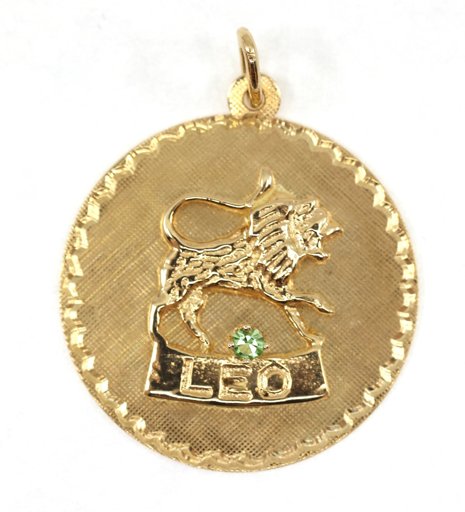 14K YELLOW GOLD ASTROLOGICAL LEO PENDANT: 14K YELLOW GOLD ASTROLOGICAL LEO PENDANT 14K yellow gold astrological sign Leo pendant with a 2.3mm round green cubic zirconia. Size: 25mm Weight: 4g