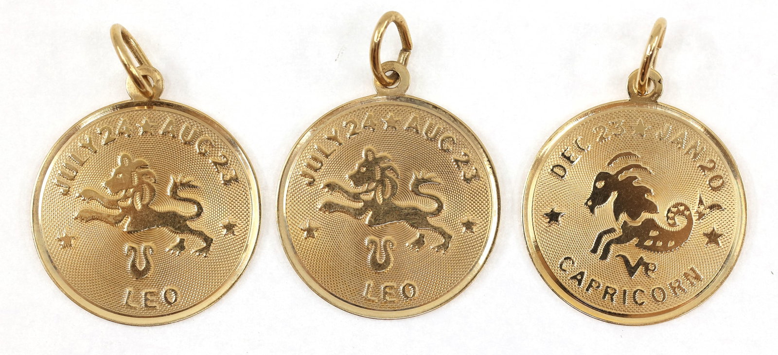 14K YELLOW GOLD ASTROLOGICAL SIGN PENDANTS: 14K YELLOW GOLD ASTROLOGICAL SIGN PENDANTS 14K yellow gold astrological sign pendants, include: (2) Leo (1) Capricorn Size: 19mm Weight: 4g