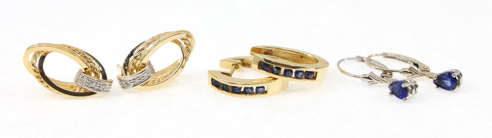 14K YELLOW GOLD BLUE SAPPHIRE & DIAMOND EARRINGS: 14K YELLOW GOLD BLUE SAPPHIRE & DIAMOND EARRINGS Three pairs of 14K yellow gold fashion earrings: Hinged hoops with round-cut blue sapphire Drop earrings with pear-cut sapphire Rope design studs