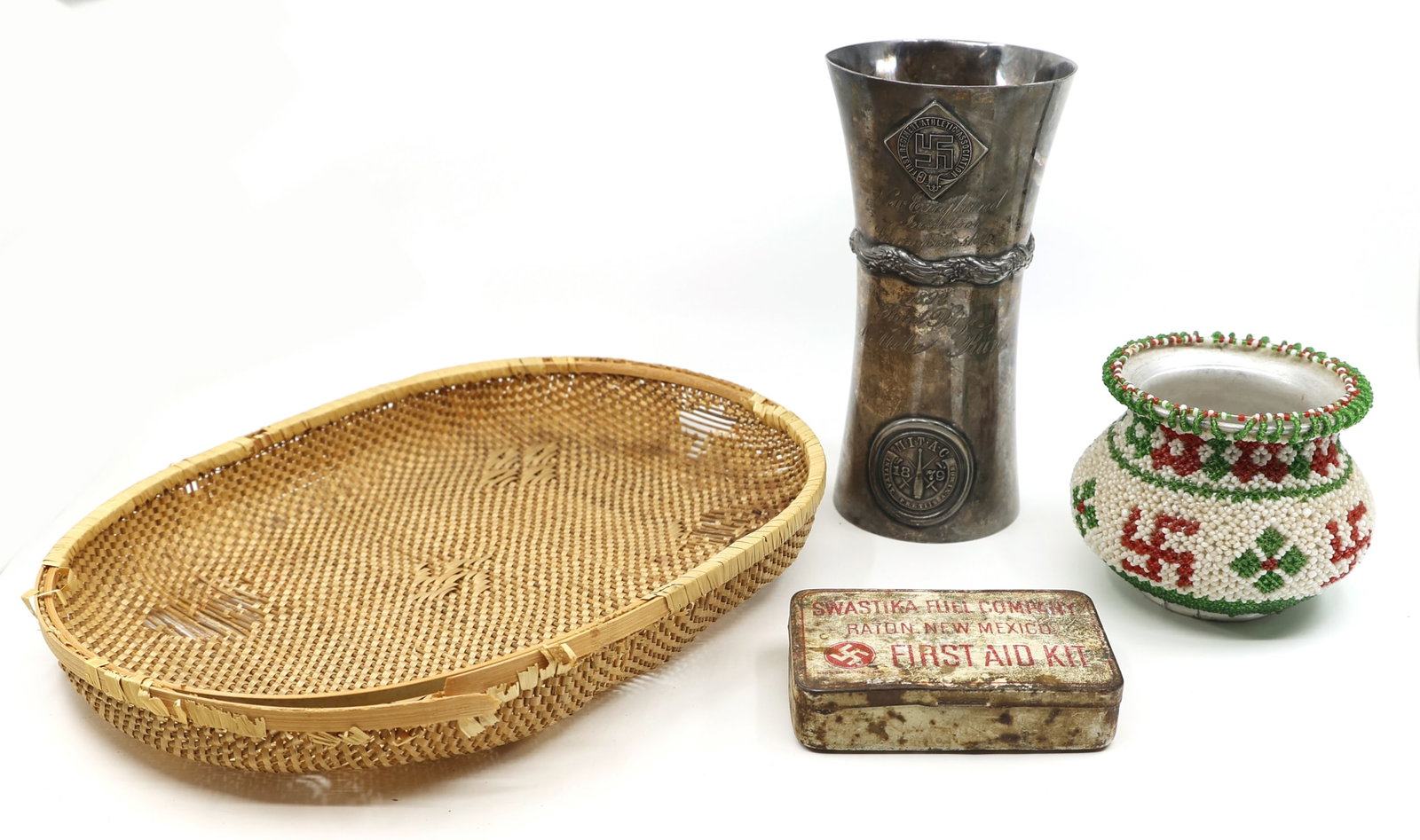GOOD LUCK SWASTIKA SOUVENIRS: GOOD LUCK SWASTIKA SOUVENIRS 20th Century good luck swastika souvenirs include: Oval bamboo woven tray, 11 x 8.5 x 2" Beaded vase 4.5 x 3.5" Swastika Fuel Company first aid kit 4 x 2.5 x 1" </