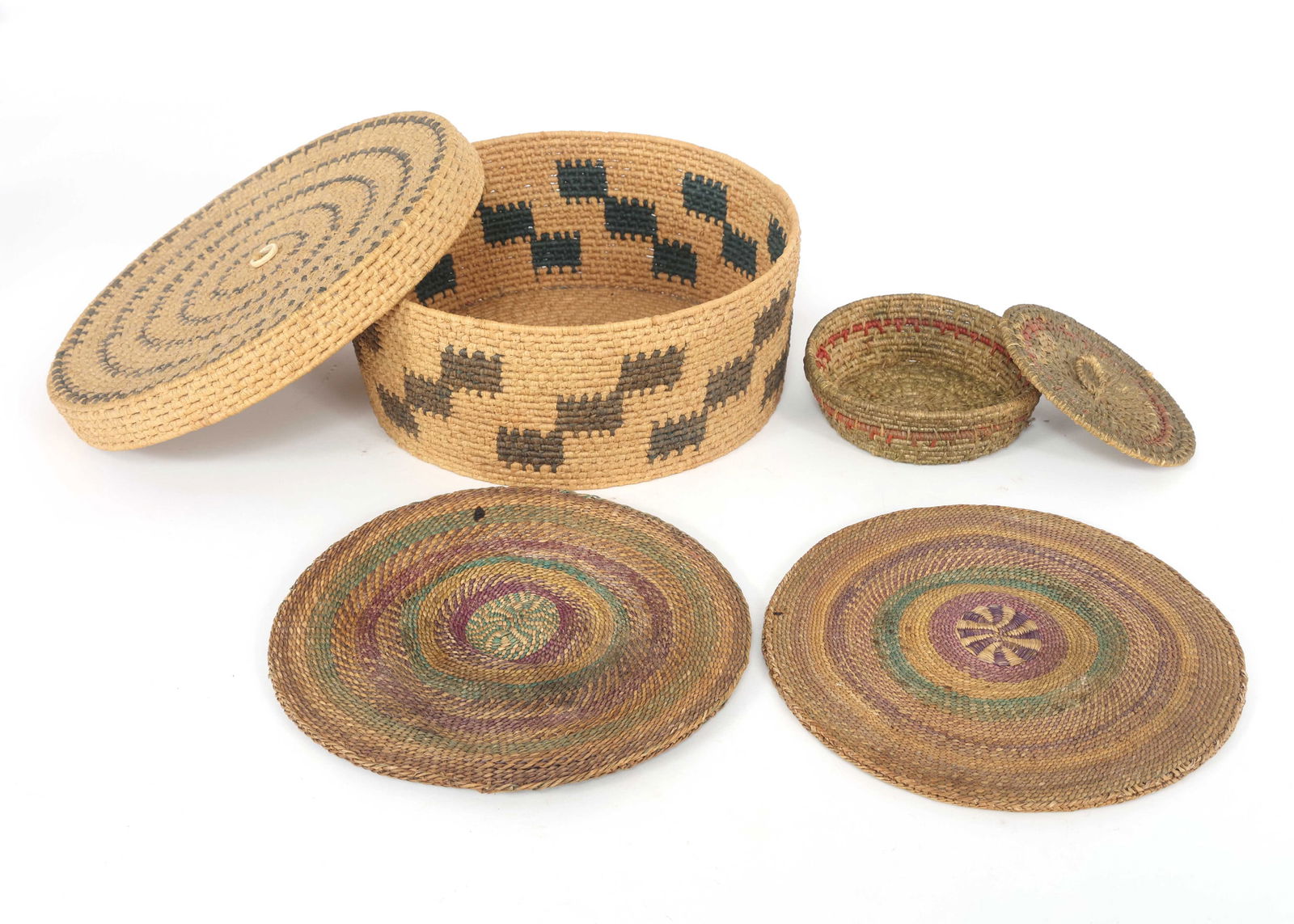NATIVE AMERICAN TRINKET COIL BASKETS & TRIVETS: NATIVE AMERICAN TRINKET COIL BASKETS & TRIVETS Two Native American trinket coil baskets (4.5 x 1.5" and 9.5 x 4") and two trivets (8" diameter). Provenance: Private Estate Collection | Colorado