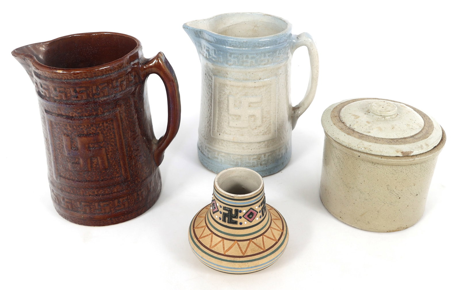 GOOD LUCK SWASTIKA SWASTIKA CERAMIC VESSELS: GOOD LUCK SWASTIKA SWASTIKA CERAMIC VESSELS 20th Century ceramic pottery. Includes: Glazed crock fermentation jar & lid with good luck swastika symbol on the handle of lid. 5.5 x 6" </