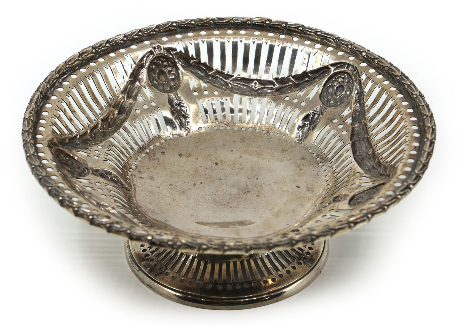 STERLING SILVER CHARLES STUART HARRIS FOOTED BASKET: STERLING SILVER CHARLES STUART HARRIS FOOTED BASKET Sterling silver Charles Stuart Harris footed basket with 1893 date mark. Size: 6" x 2.25" Weight: 179g