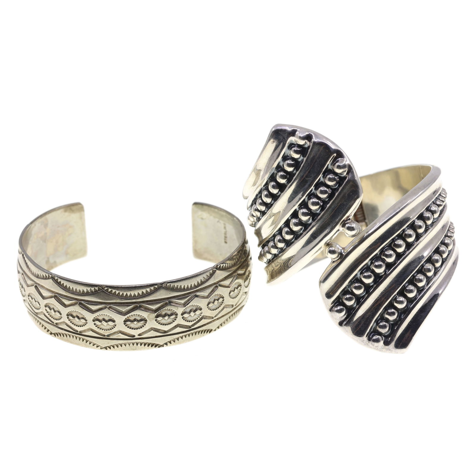 STERLING SILVER CUFF BRACELETS: STERLING SILVER CUFF BRACELETS Sterling silver cuffs: Hinge cuff (6") Engraved cuff (6.75") Weight: 92g