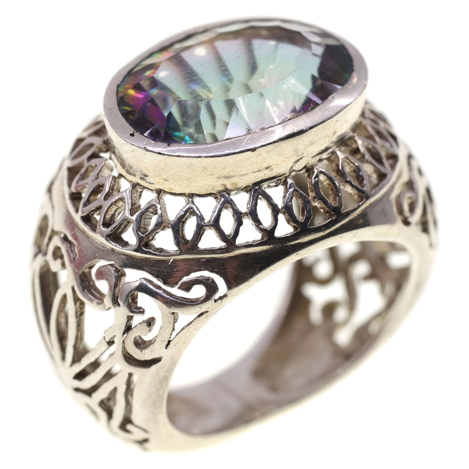 STERLING SILVER RAINBOW SPINEL OPEN-WORK FASHION RING: STERLING SILVER RAINBOW SPINEL OPEN-WORK FASHION RING Sterling silver fashion ring with open-work design and 10.5 x 16mm oval cut rainbow spinel. Size: 7 Weight: 11g