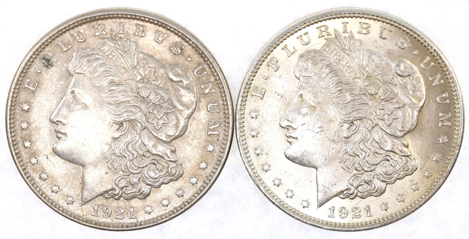 1921-P US SILVER MORGAN DOLLAR AU COINS: 1921-P US SILVER MORGAN DOLLAR AU COINS Two 1921-P United States .900 silver Morgan $1 coins, both AU condition. IMPORTANT NOTE - PLEASE READ: OUR IN-HOUSE SHIPPING & INVOICING Shipping: LiveAuc