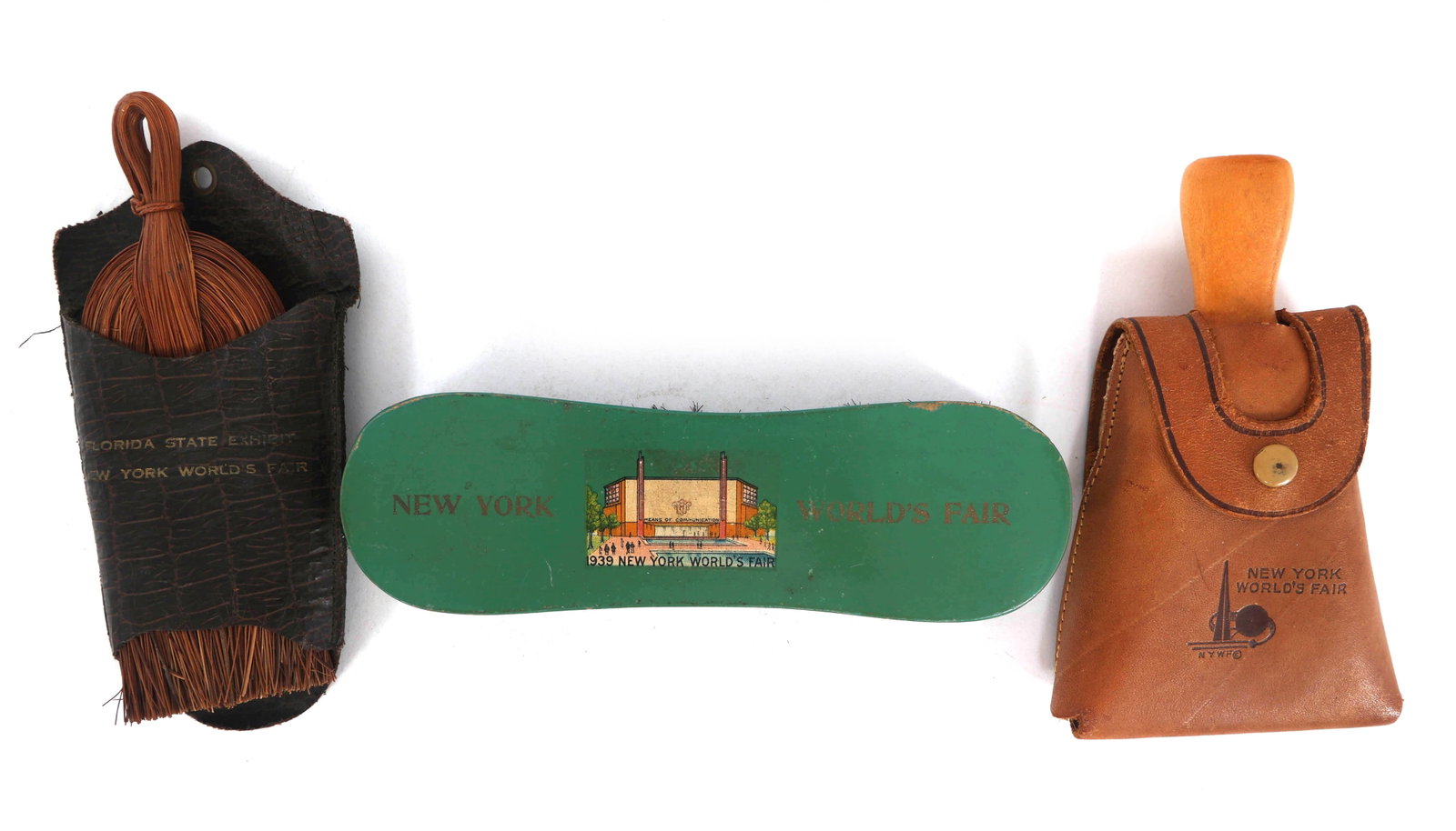 NEW YORK WORLD'S FAIR 1939 CLOTHING BRUSHES: NEW YORK WORLD'S FAIR 1939 CLOTHING BRUSHES 1939 New York World's Fair clothing brushes: Green brush (6.75" x 2" x 1.5") Brush in leather case (5.75" x 3.5" x 1") Florida State Exhibit brush (6.25" x