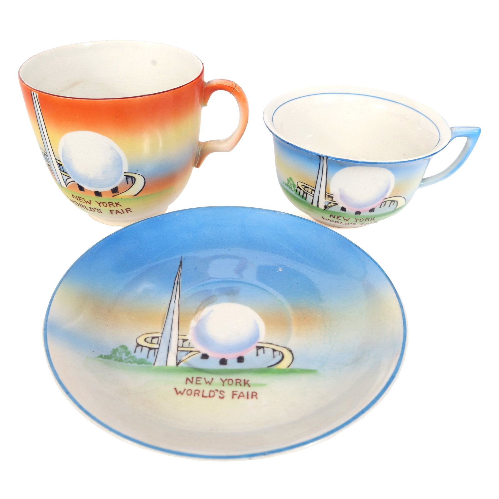 NY WORLD'S FAIR 1939 HAND-PAINTED JAPANESE TEA CUPS: NY WORLD'S FAIR 1939 HAND-PAINTED JAPANESE TEA CUPS New York World's Fair 1939 Hand-Painted Japanese Tea Cups Orange teacup 4"x3"x3" Blue teacup 4.25"x3.5"x2" Plate 5.25" <