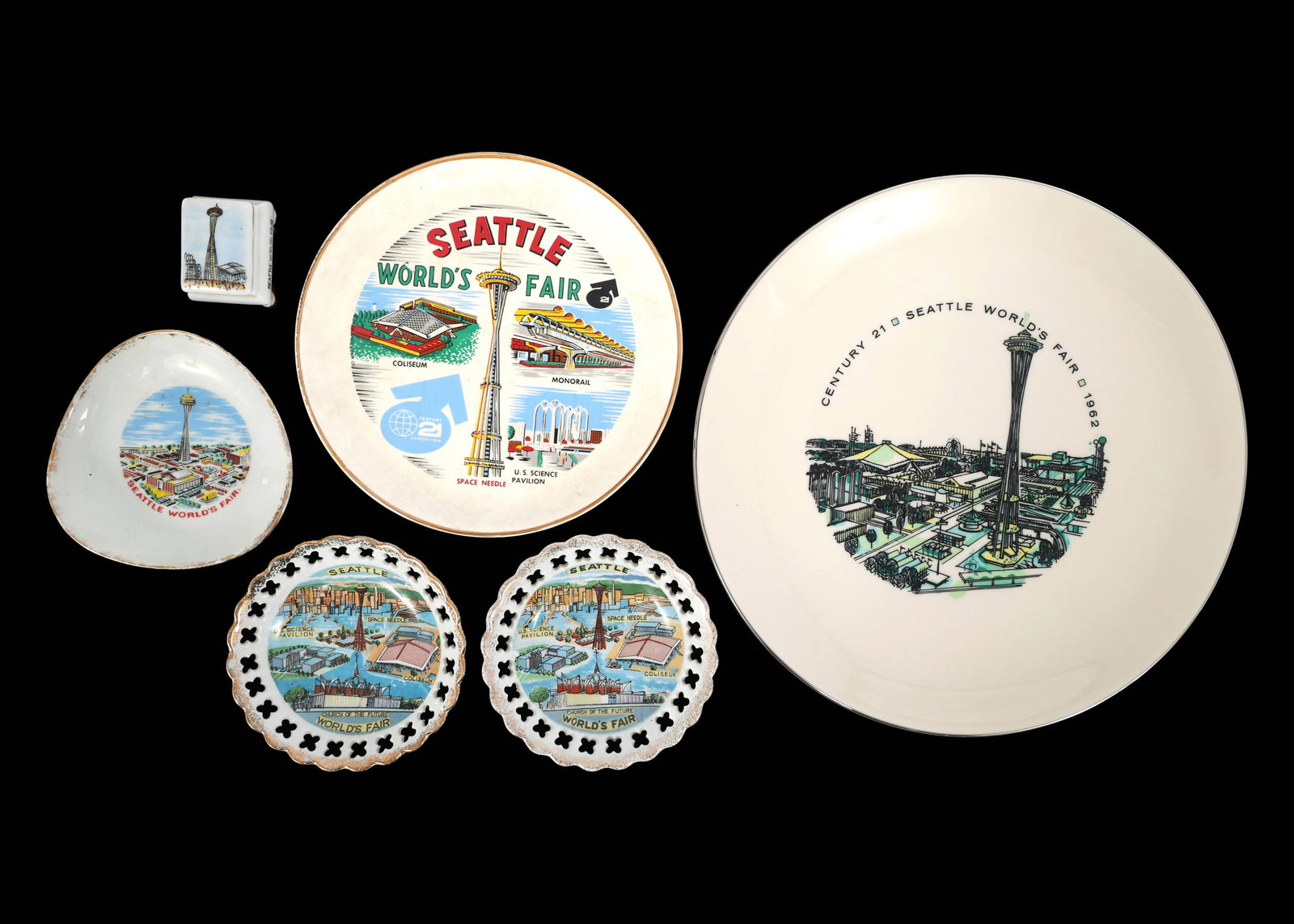 SEATTLE WORLD'S FAIR 1962 PORCELAIN COLLECTIBLES: SEATTLE WORLD'S FAIR 1962 PORCELAIN COLLECTIBLES 1962 Seattle World's Fair porcelain collectibles: Miniature trinket box (2" x 1.5" x 1.75") (2) Plates (7" - 10.5") (3) Dishes (4.25" - 4.5")