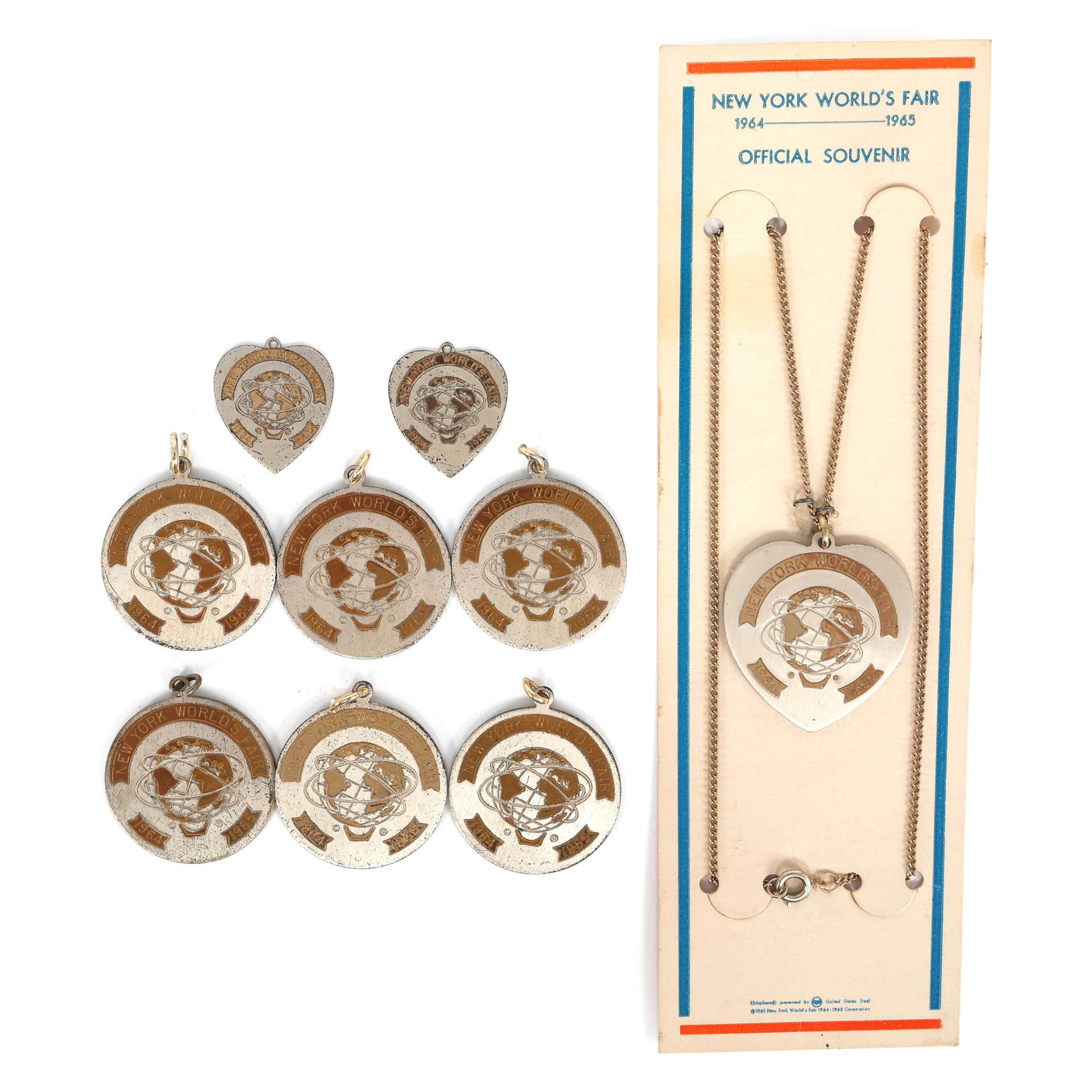 NEW YORK WORLD'S FAIR 1964 SOUVENIR NECKLACE & PENDANTS: NEW YORK WORLD'S FAIR 1964 SOUVENIR NECKLACE & PENDANTS 1964-65 New York World's Fair souvenir necklace & pendants: Necklace with a heart pendant (17") (8) Pendants: (2) Heart <