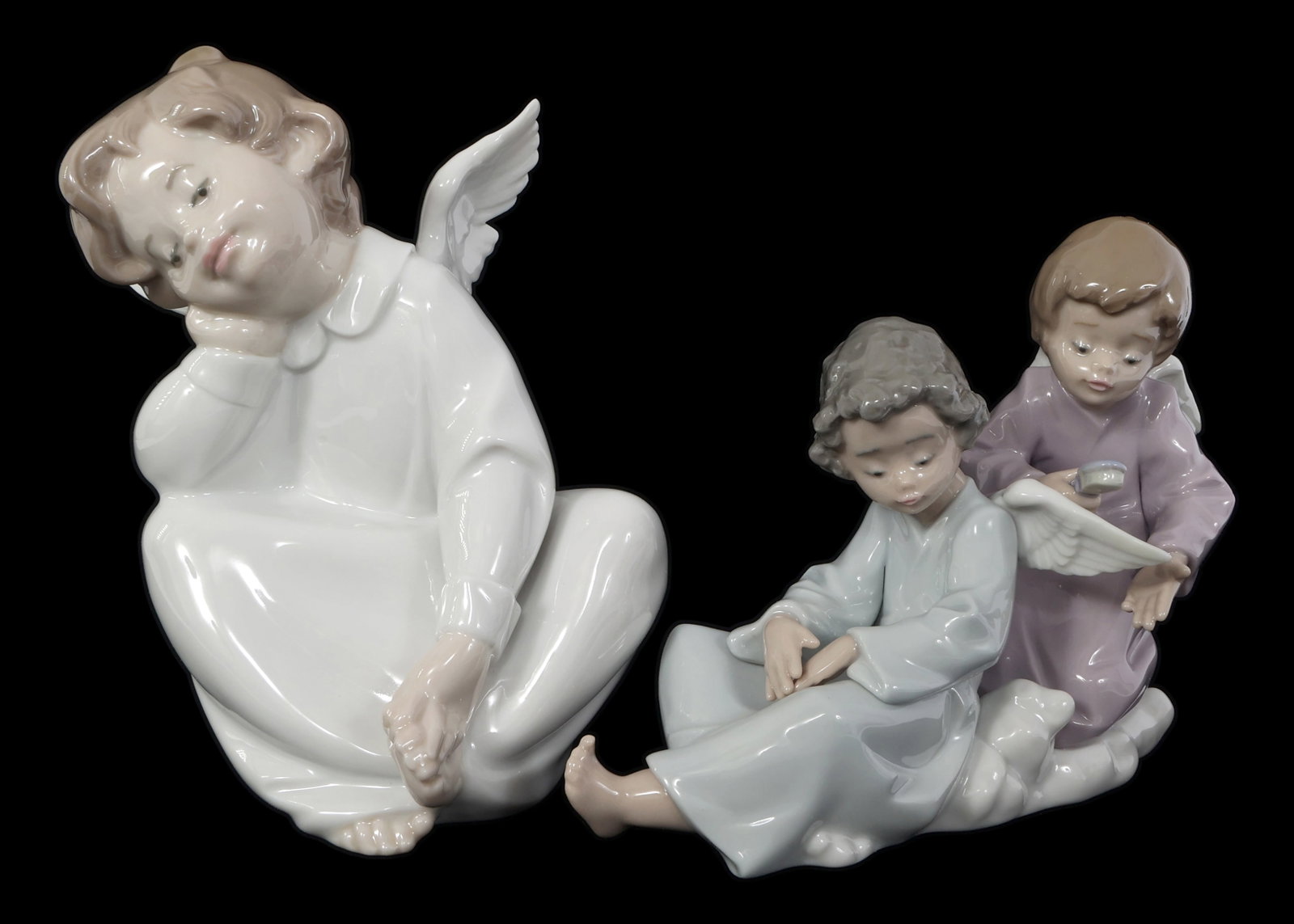 LLADRO PORCELAIN FIGURINES - LOT OF 2: LLADRO PORCELAIN FIGURINES - LOT OF 2 Lladro Porcelain Figurines. Includes: Cherub, Dreaming #04961 Angel Care #05727 Includes original boxes. IMPORTANT