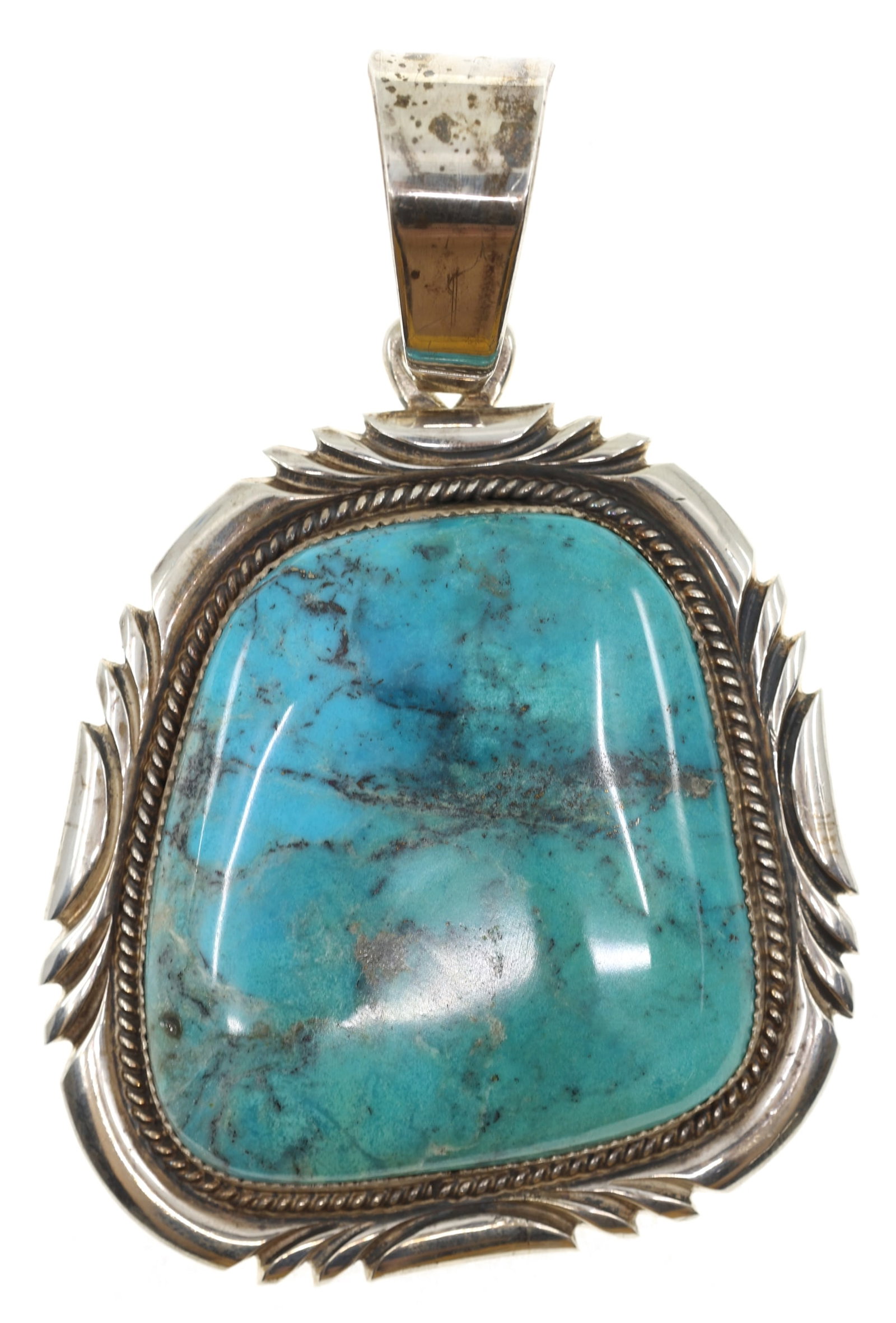 STERLING SILVER MARK YAZZIE OVERSIZE TURQUOISE PENDANT: STERLING SILVER MARK YAZZIE OVERSIZE TURQUOISE PENDANT Sterling silver pendant with a 51 x 55mm asymmetrically cut turquoise, by Navajo silversmith, Mark Yazzie. Signed/stamped with the artist's 
