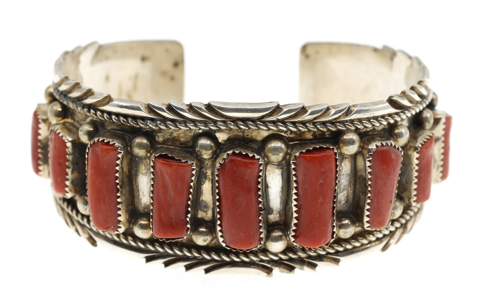STERLING SILVER RAY BEGAY RED CORAL CUFF BRACELET: STERLING SILVER RAY BEGAY RED CORAL CUFF BRACELET Sterling silver and red coral cuff bracelet by Navajo silversmith, Ray Begay. Signed/stamped with the artist's name on the interior. Size: 8" Wei