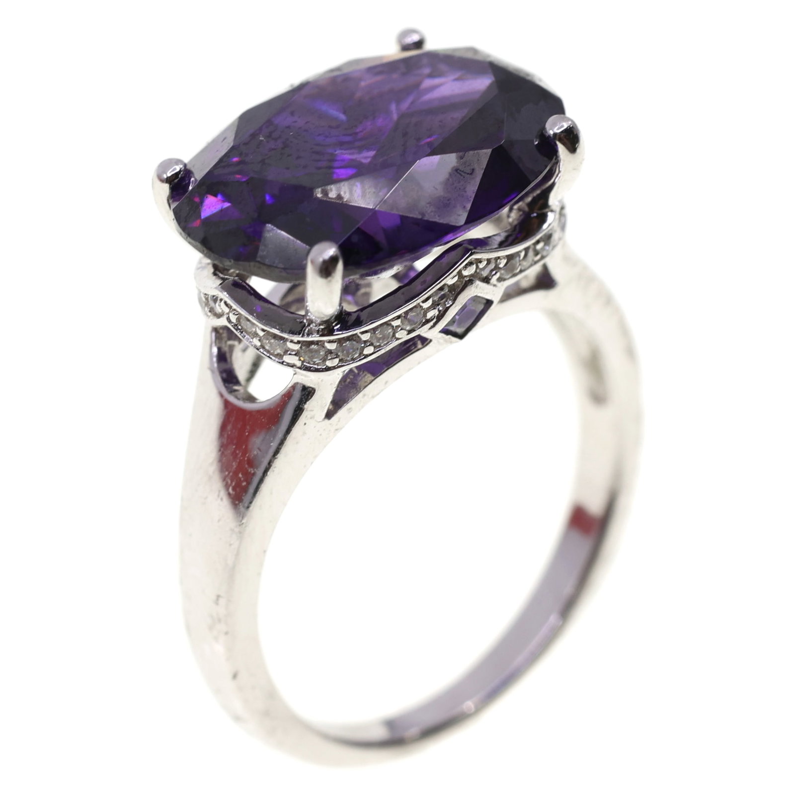 STERLING SILVER TOURMALINE & CUBIC ZIRCONIA RING: STERLING SILVER TOURMALINE & CUBIC ZIRCONIA RING Sterling silver tourmaline & cubic zirconia fashion ring Oval purple tourmaline (16mm x 12mm) (2) Square purple tourmaline (2mm) (28) Round