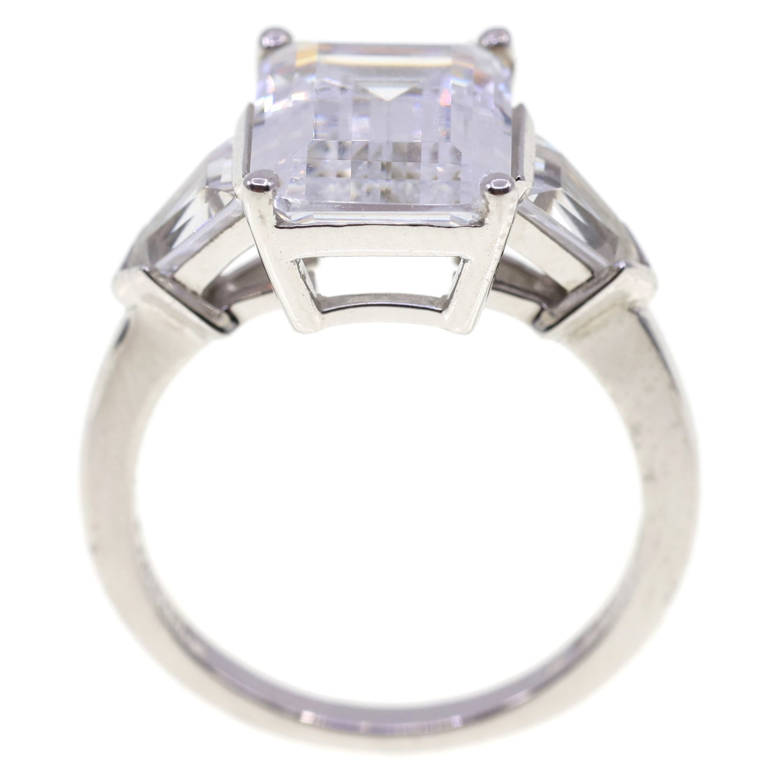STERLING SILVER CUBIC ZIRCONIA ENGAGEMENT RING: STERLING SILVER CUBIC ZIRCONIA ENGAGEMENT RING Sterling silver cubic zirconia engagement ring: Emerald cut (12mm x 9mm) (2) Fancy cut (6mm x 4.25mm) Size: 8 Weight: 5g IMPORTANT NOTE - PLEASE