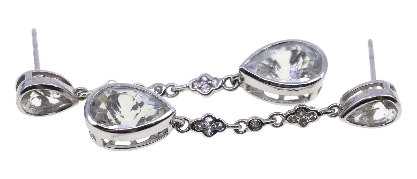 14K WHITE GOLD LIGHT BLUE TOPAZ DROP EARRINGS: 14K WHITE GOLD LIGHT BLUE TOPAZ DROP EARRINGS 14K white gold drop earrings, each with: (1) 6 x 9mm pear cut light blue topaz (1) 4 x 6mm pear cut light blue topaz (9) 0.0025 ct round accent dia