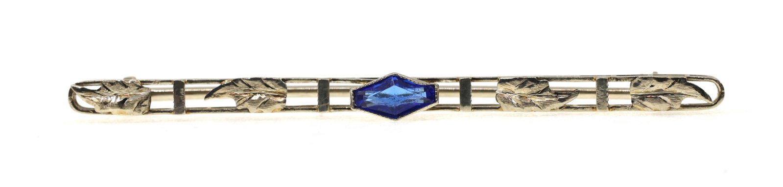 10K WHITE GOLD TANZANITE BROOCH: 10K WHITE GOLD TANZANITE BROOCH 10K white gold brooch with a 6.25 x 3.5mm fancy-cut tanzanite. Size: 2" Weight: 1g IMPORTANT NOTE - PLEASE READ: REGARDING OUR IN-HOUSE SHIPPING & INVOICING Shipping: A