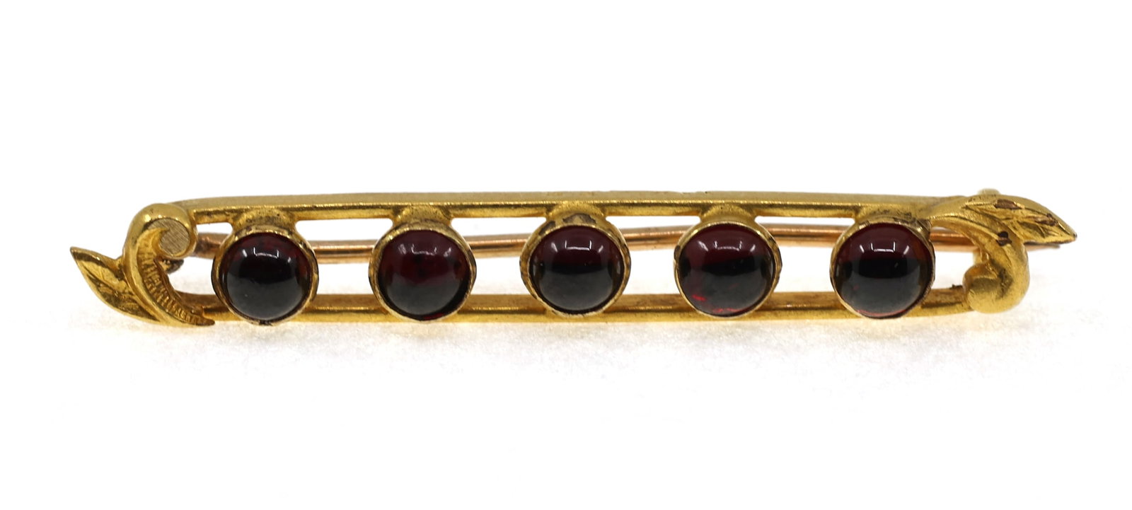 14K YELLOW GOLD CABOCHON GARNET BROOCH: 14K YELLOW GOLD CABOCHON GARNET BROOCH 14k yellow gold brooch with (5) 3.5mm round cabochon cut garnet. Size: 1.5" Weight: 2g IMPORTANT NOTE - PLEASE READ: REGARDING OUR IN-HOUSE SHIPPING & INVOICING 