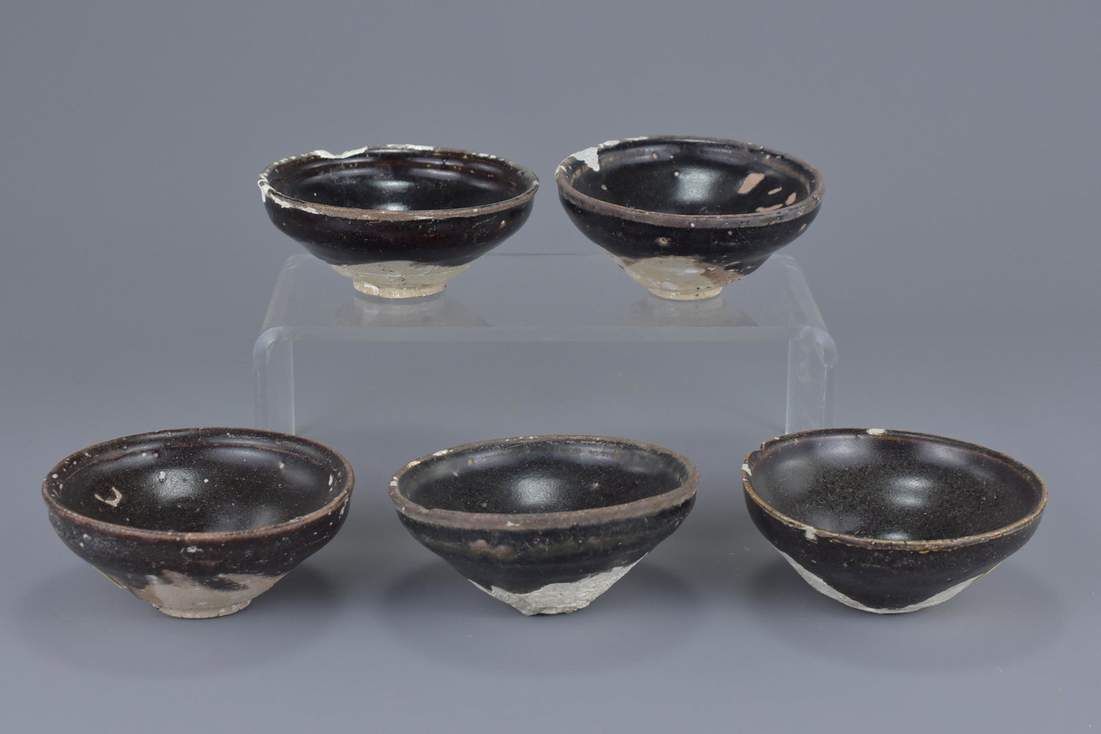 A group of five Chinese Song dynasty (960-1279) black: A group of five Chinese Song dynasty (960-1279) black glazed pottery tea bowls. 10Cm diam.