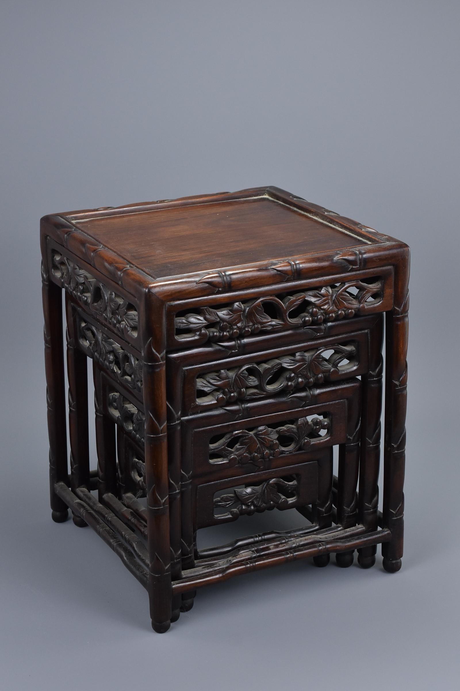 A nest of four miniature Chinese 19th Century Hongmu: A nest of four miniature Chinese 19th Century Hongmu stands finely carved with flowers and grapes. Smallest 13cm height x 15cm width - Largest 31cm height x 24cm widthÂ Provenance: English private 