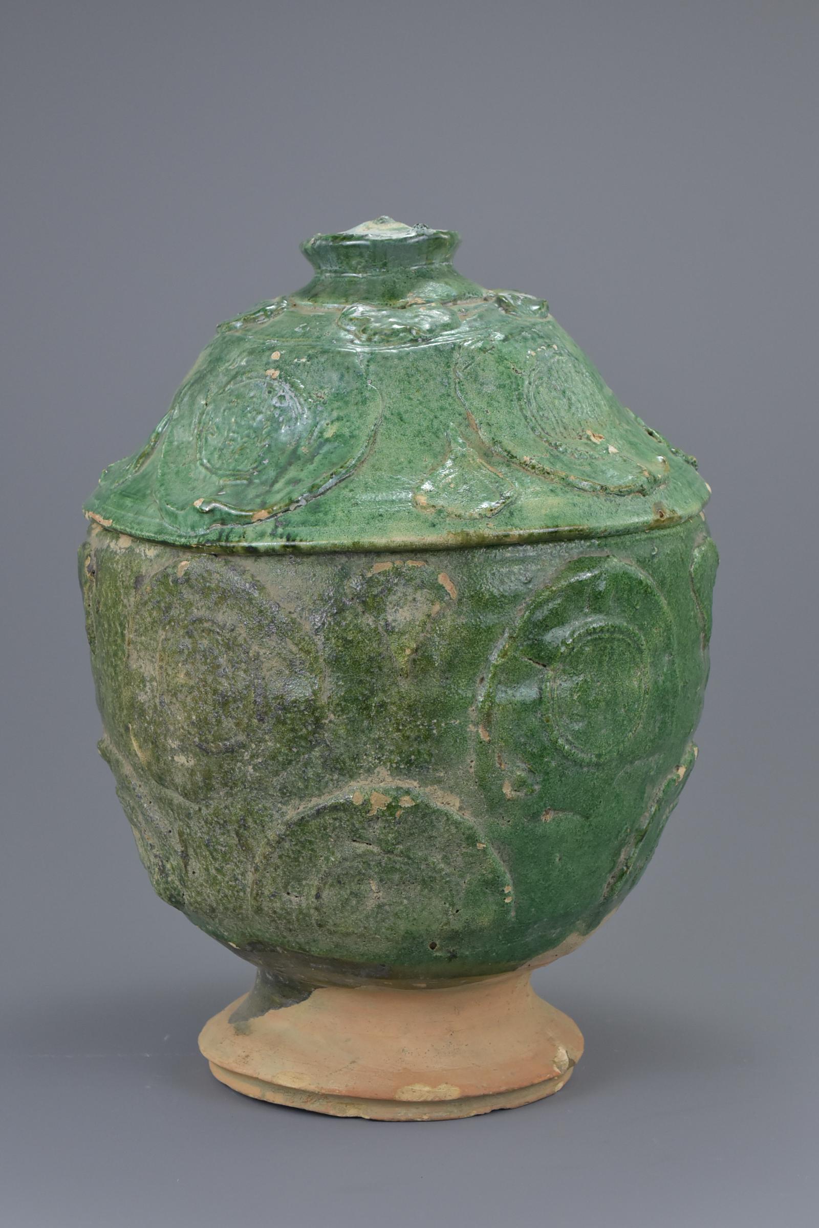 A Chinese Song / Yuan Dynasty green glazed Buddhist jar: A Chinese Song / Yuan Dynasty green glazed Buddhist jar and cover. The cover interior with painted sanskrit-type characters. 36cm tall Provenance: From an English private collection in Buckinghamshire
