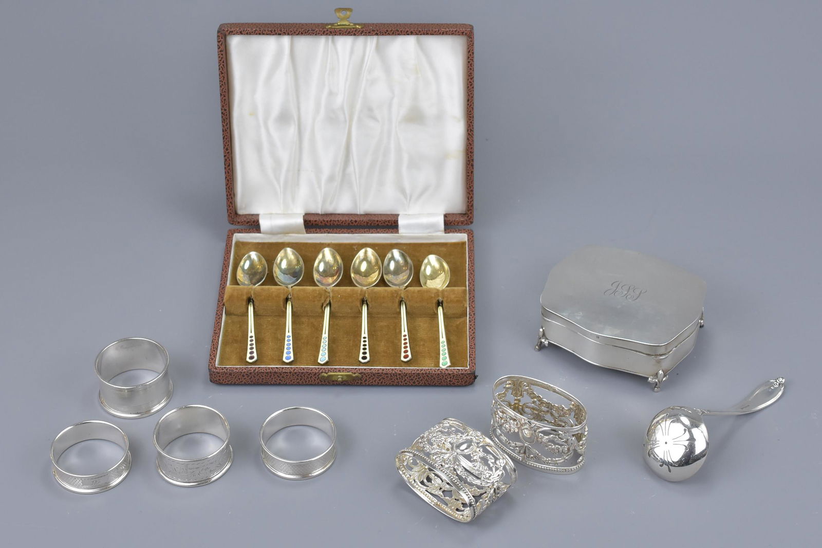 A group of four silver hallmarked napkin rings together (1 of 4)