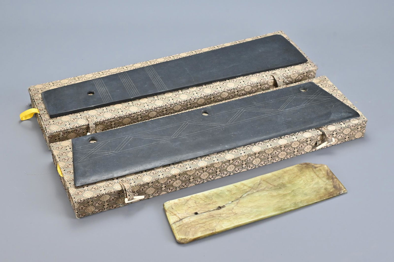 Three Chinese Neolithic Style Stone Axes: Three Chinese Neolithic Style Stone Axes in two decorative boxes. Longest 38 cm (3)