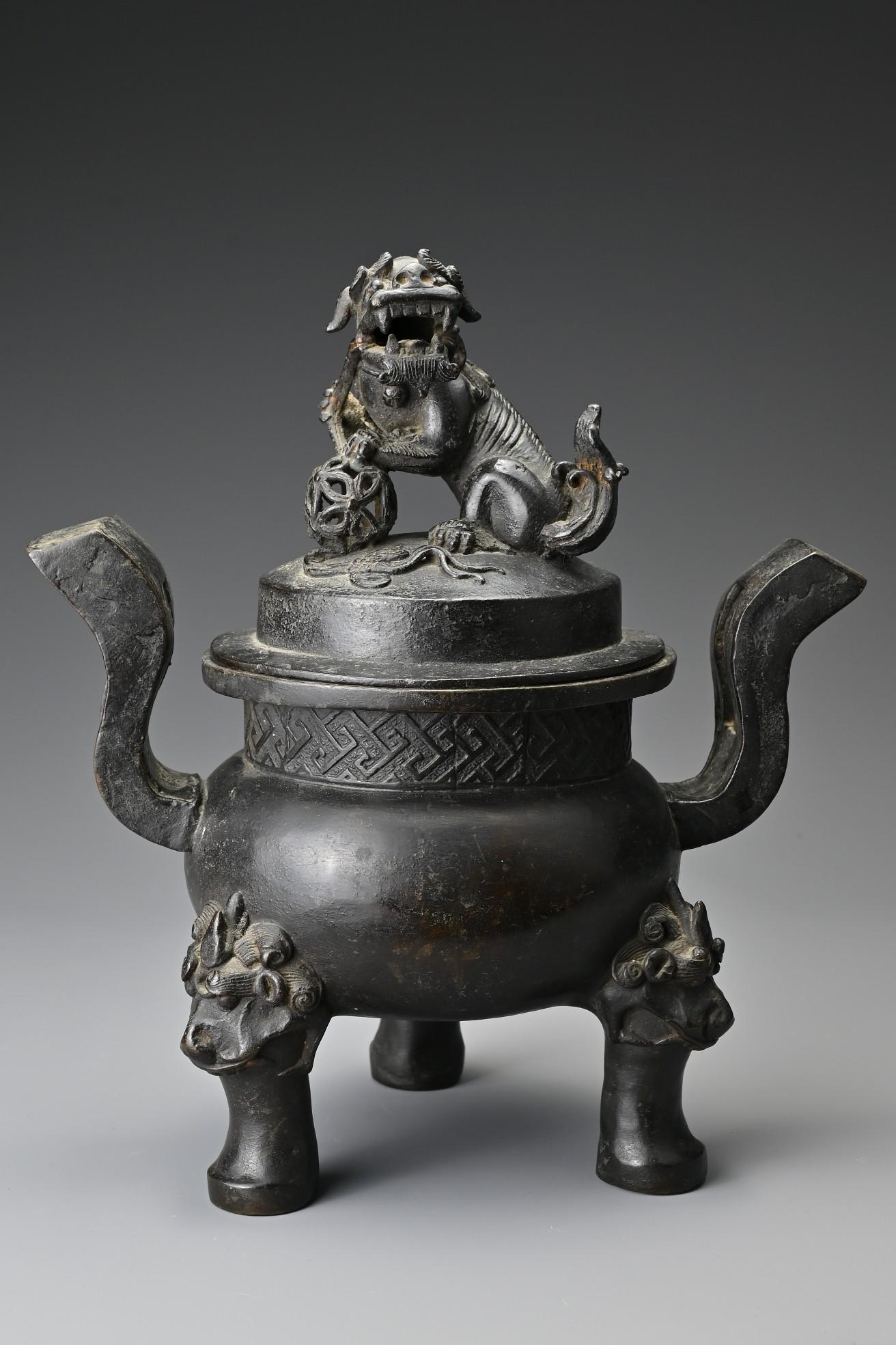 A Chinese Ming dynasty bronze tripod censer and cover. (1 of 6)