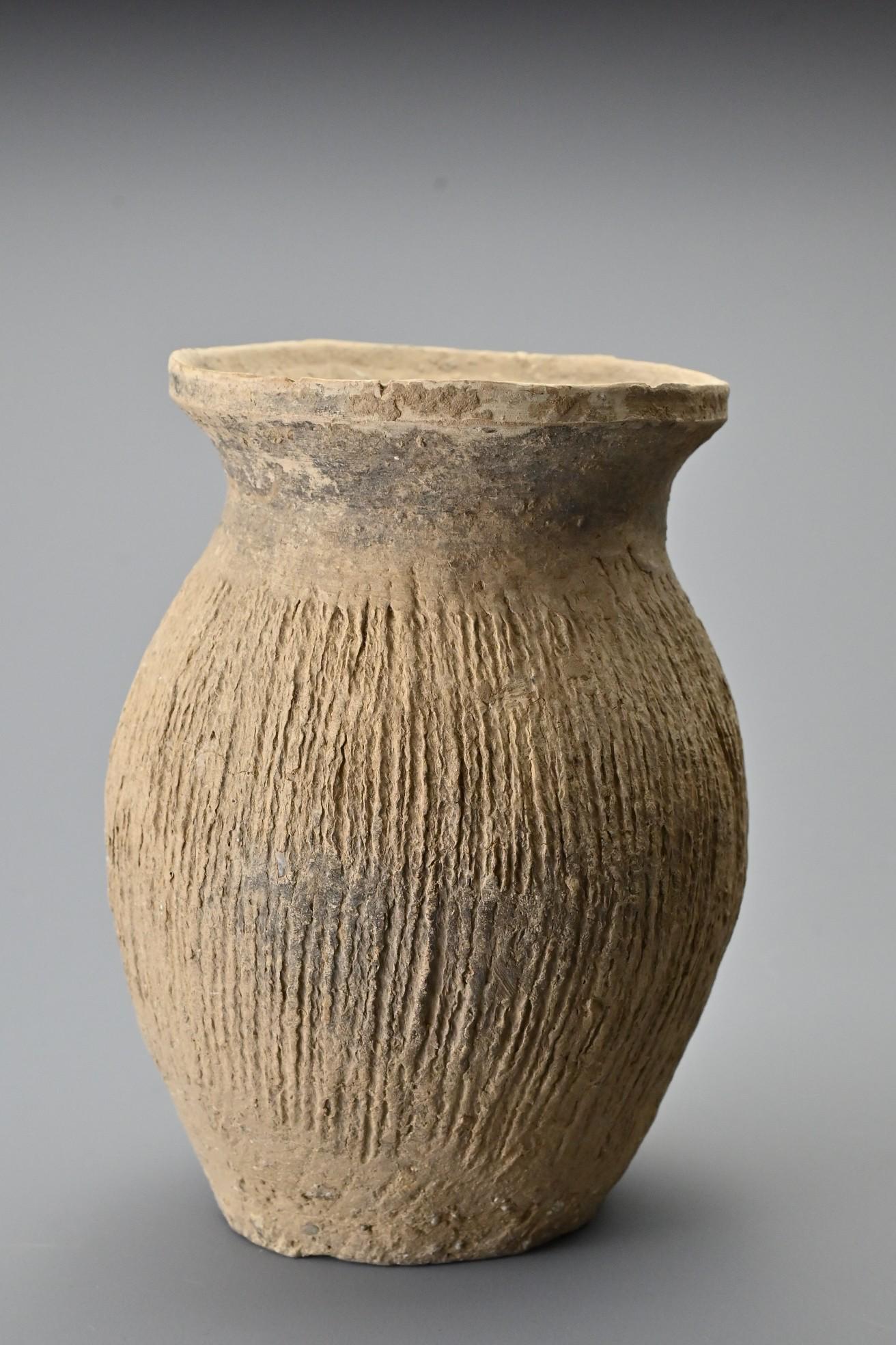 A Chinese Neolithic pottery jar. With oval shaped body (1 of 8)