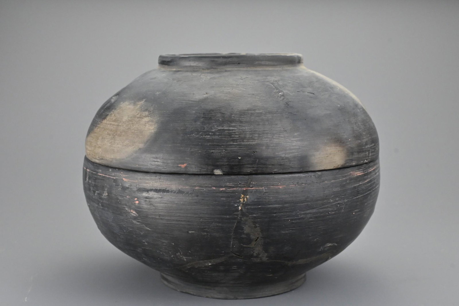 A Chinese Han dynasty (206BC - 22AD) burnished ceramic: A Chinese Han dynasty (206BC - 22AD) burnished ceramic bowl. Domed bowl and cover each with raised central ring. 16cm height x approx. 21.5cm diam. Ex Abelita collection formed 1970 - 2000s.