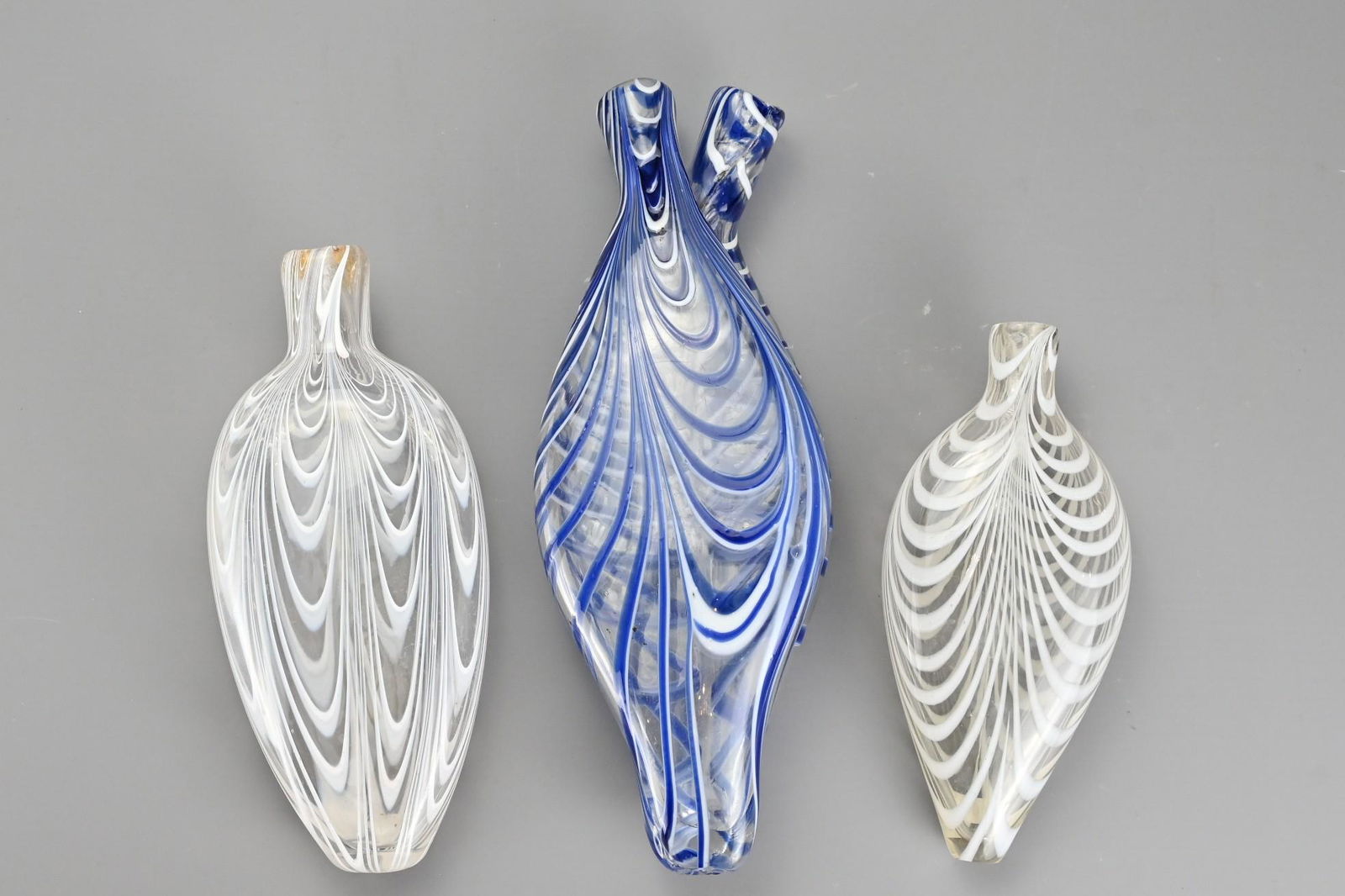Three Bristol Nailsea Glass Flasks, 19th Century, one: Three Bristol Nailsea Glass Flasks, 19th Century, one clear glass decorated with white trailing, one clear double flask with blue and white trailing and one clear glass with white trailing, largest 28