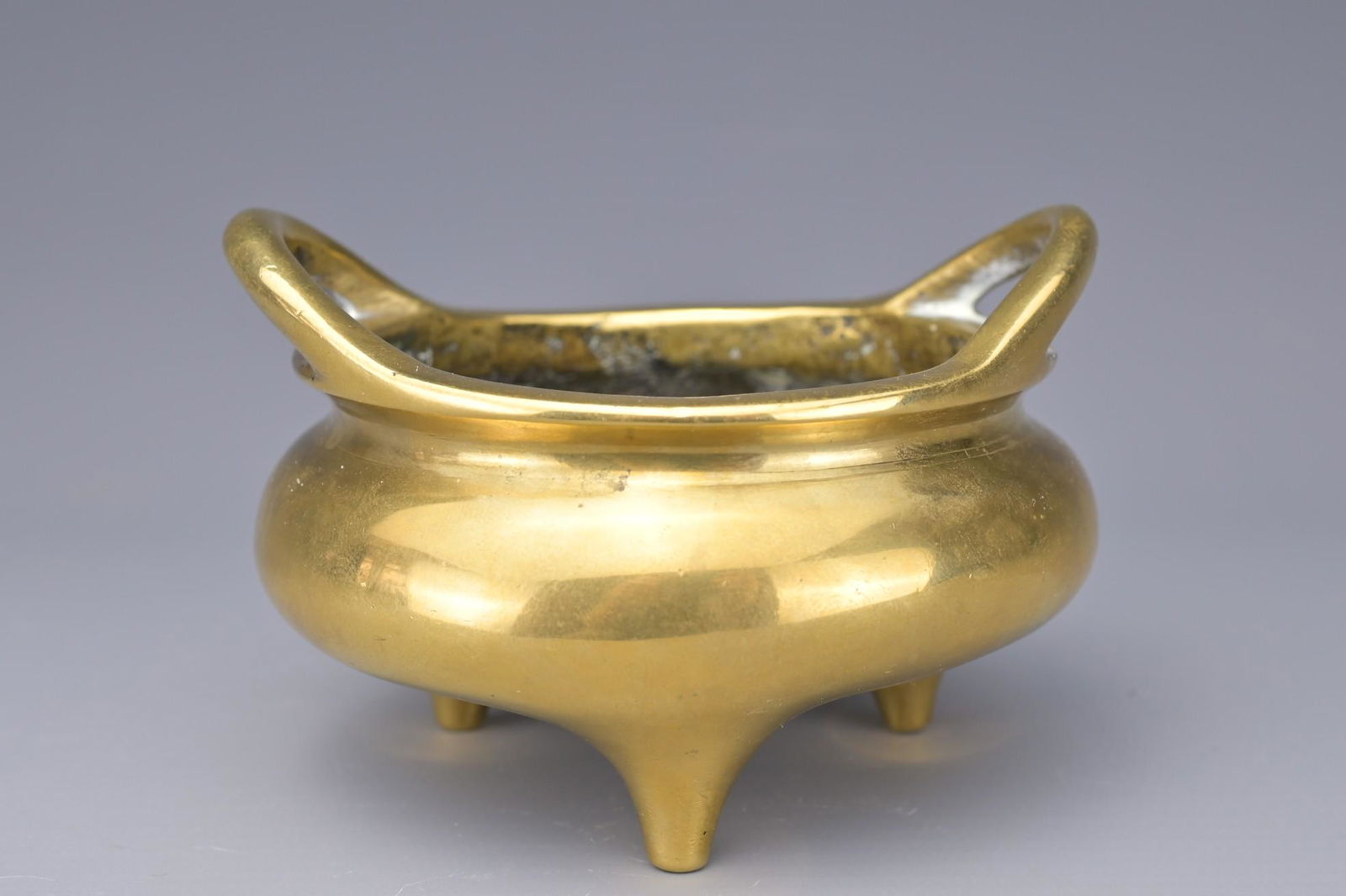 A CHINESE POLISHED BRONZE TRIPOD CENSER (1 of 7)