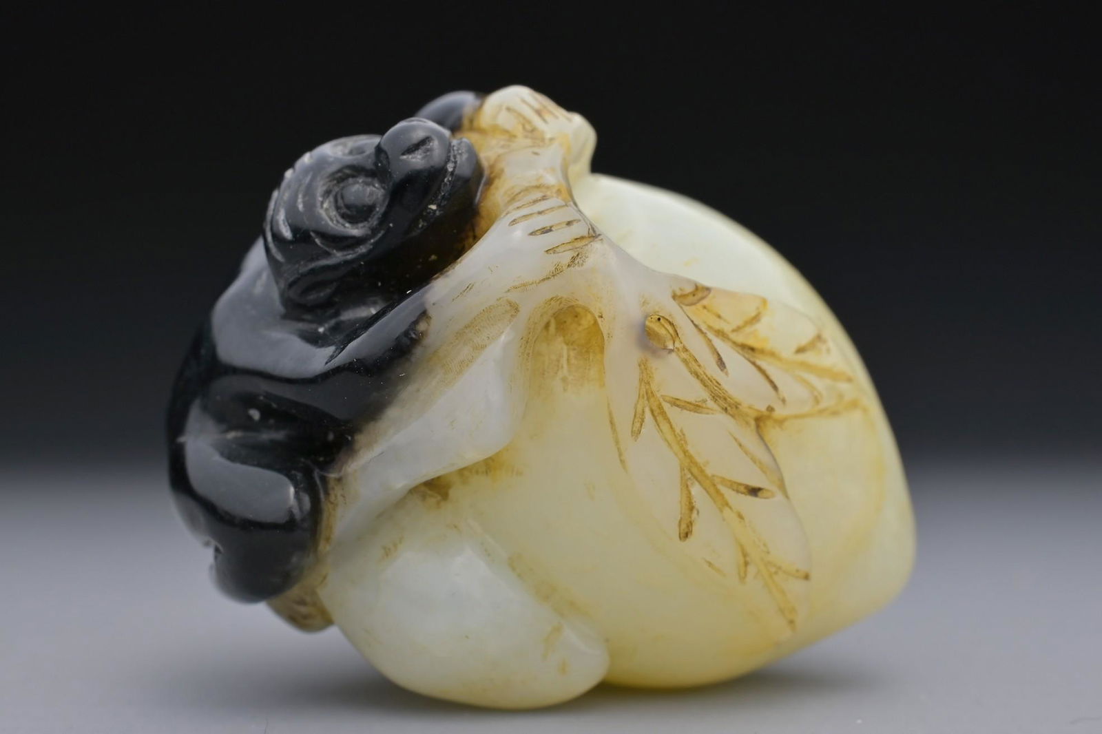 A CHINESE PALE CELADON AND BLACK JADE PENDANT OF MONKEY ON PEACH (1 of 10)