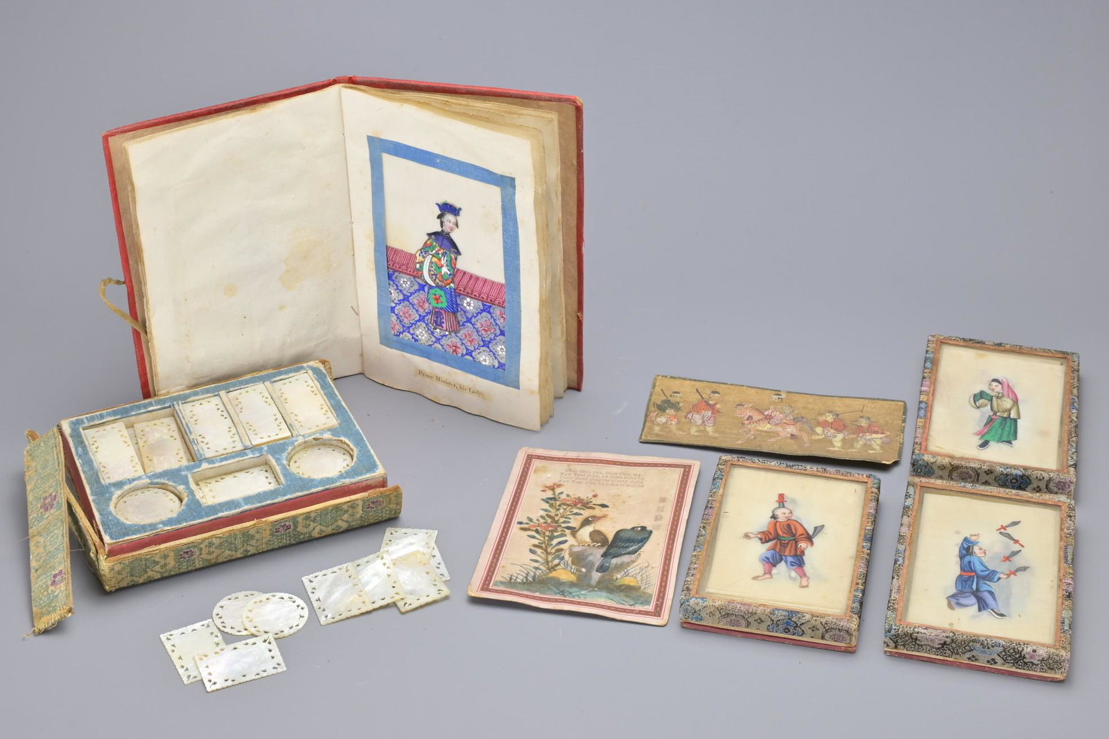 A COLLECTION OF CHINESE RICE PAPER PAINTINGS AND GAMES COUNTERS, 19TH CENTURY: A COLLECTION OF CHINESE RICE PAPER PAINTINGS AND GAMES COUNTERS, 19TH CENTURY. To include a book of ten rice paper paintings mounted on paper in a silk backed book with English description. Thirty-fiv