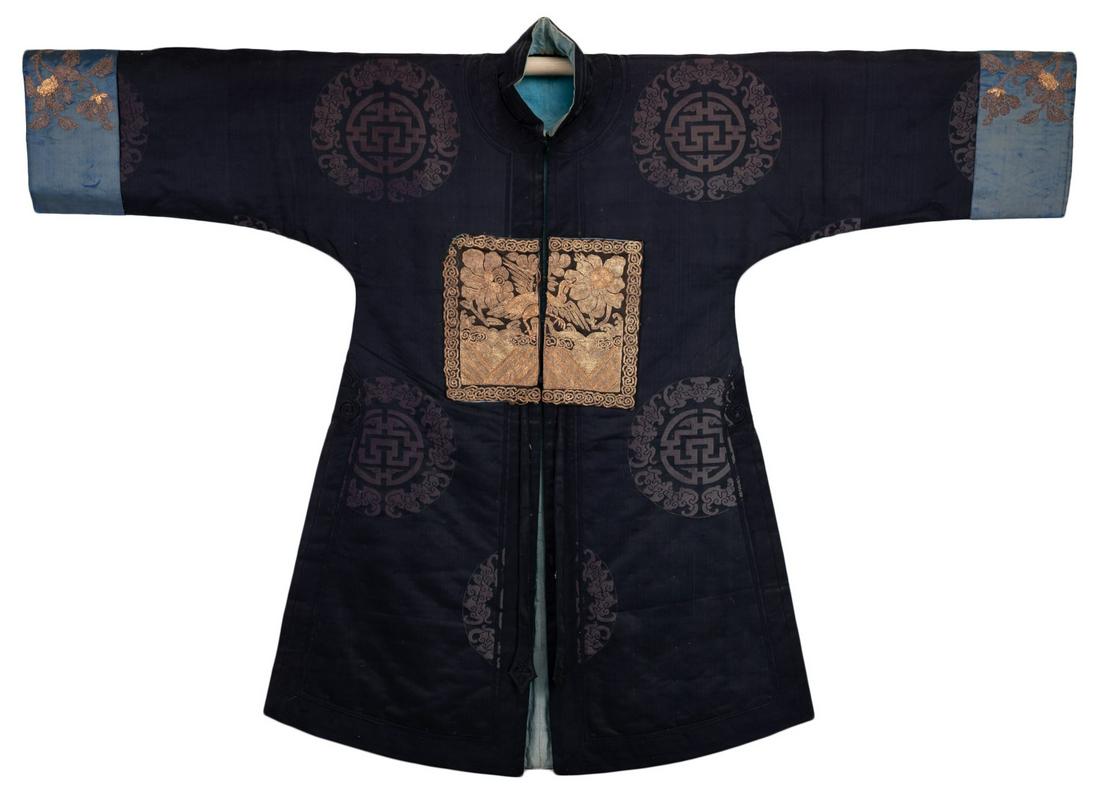 A RARE CHINESE WOMEN'S SURCOAT, FOURTH RANK, QING DYNASTY: A RARE CHINESE WOMEN'S SURCOAT, FOURTH RANK, QING DYNASTY. The padded black silk coat with front and back gold thread insignia badge of the fourth civil rank, wild goose. Decorated further with bats a