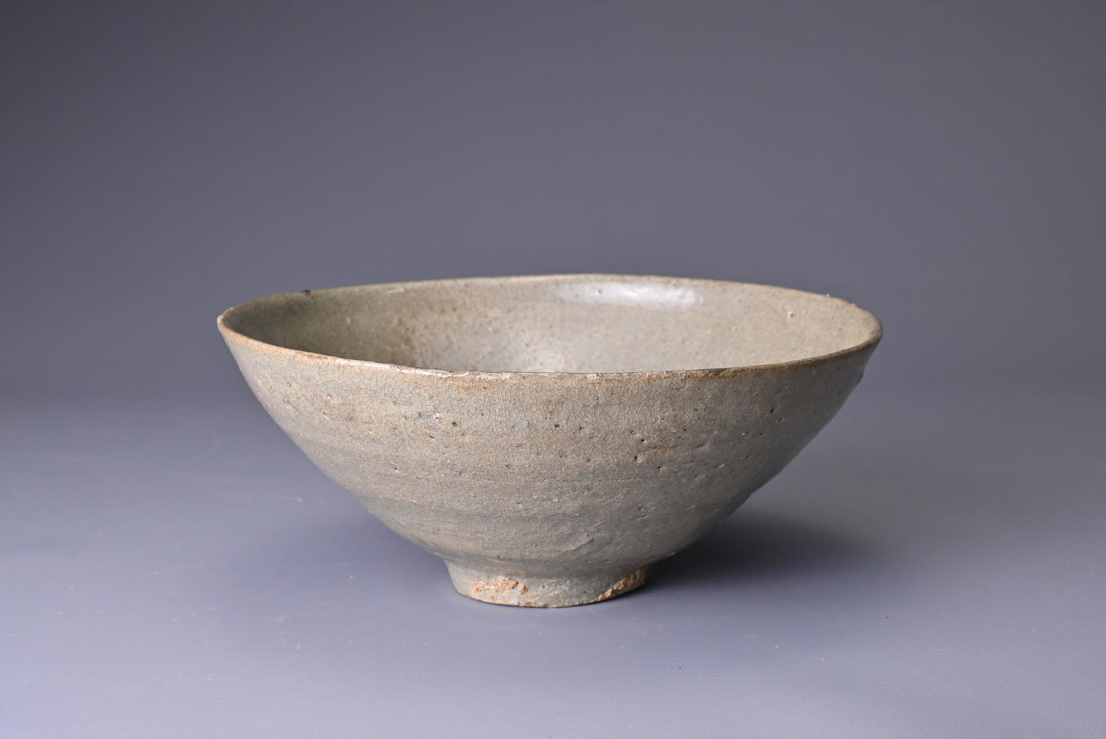 A KOREAN CELADON GLAZED BOWL, KORYO DYNASTY (AD 918 - 1392). Glazed all over in quite a thick and (1 of 6)