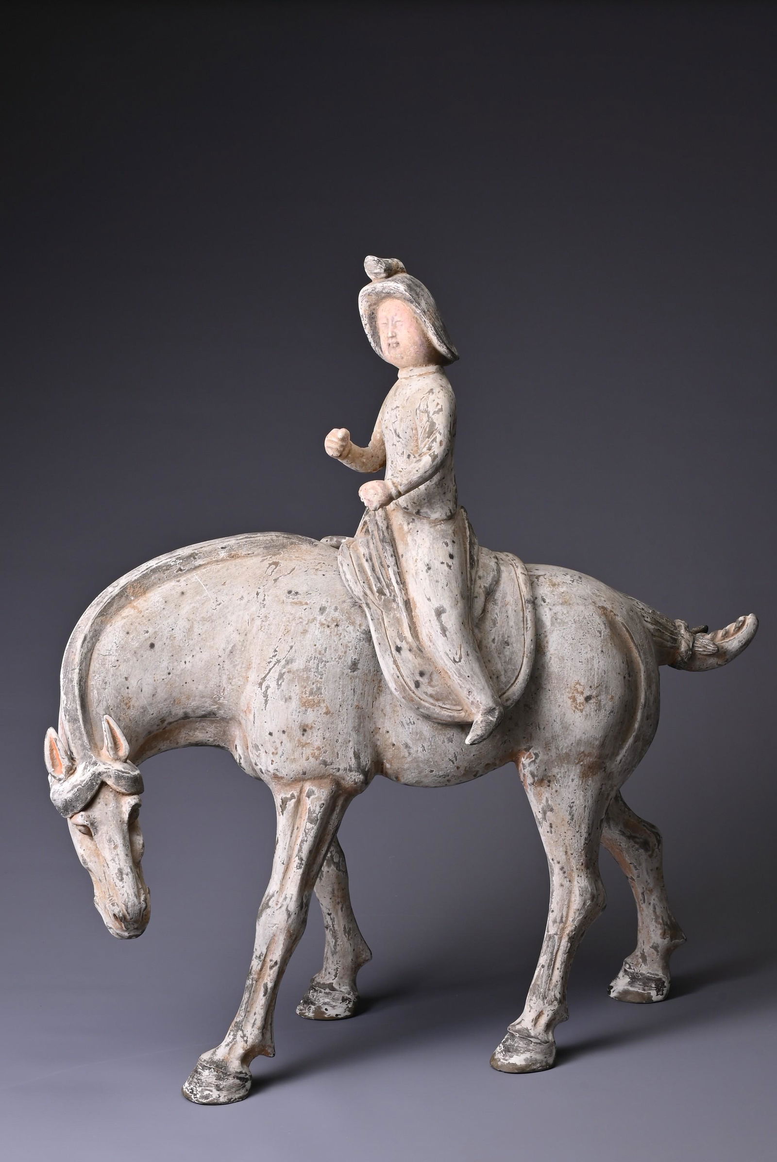 A LARGE CHINESE PAINTED POTTERY HORSE WITH A FEMALE RIDER, WITH TL TEST. The rider modelled (1 of 11)