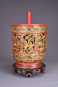 A LARGE CHINESE RED AND GILT WOOD BOX, 19TH CENTURY. Of cylindrical form on a ruyi base, well carved (1 of 7)