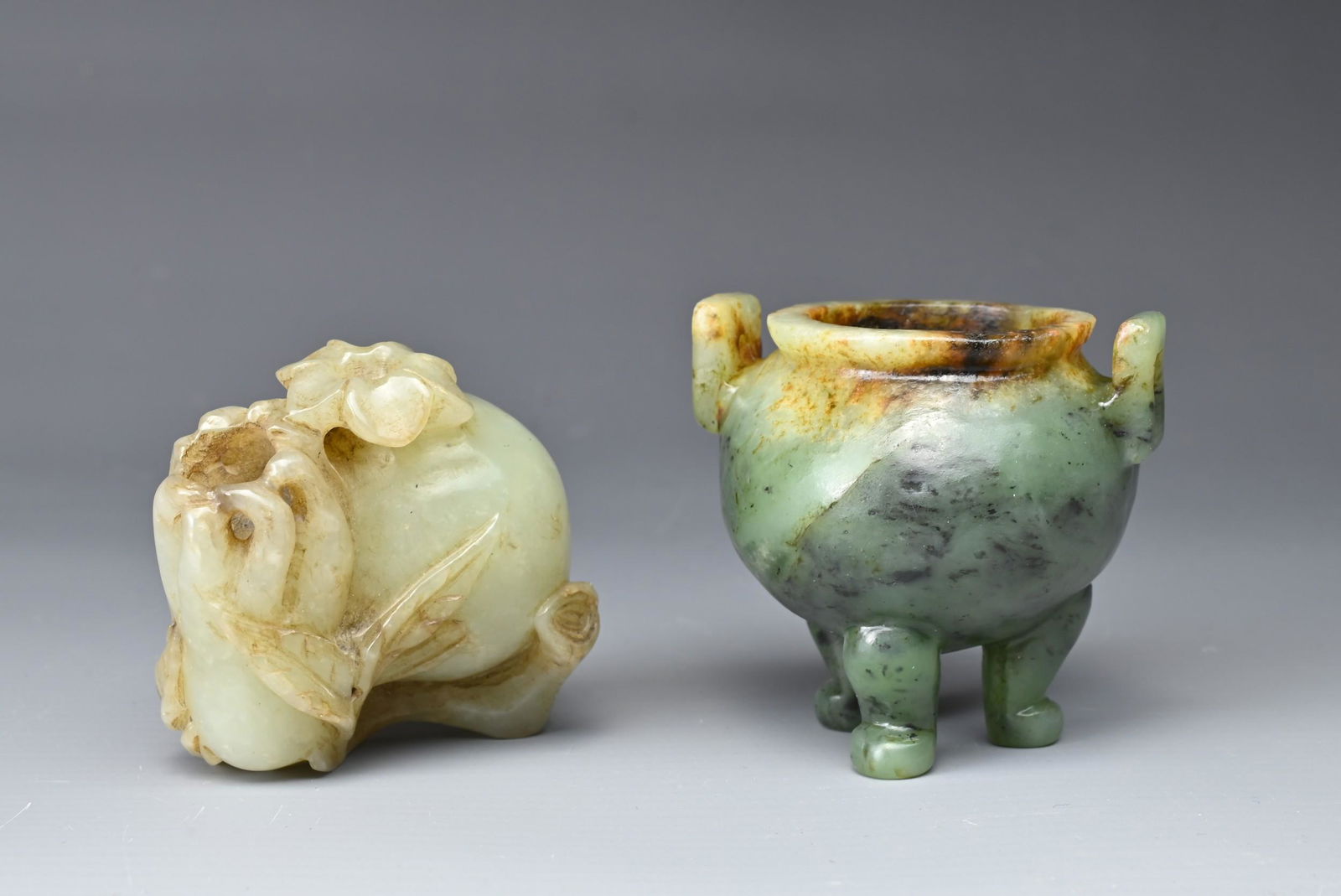 TWO CHINESE CARVED JADE ITEMS. Comprising: a tripod censer of mottled spinach colour, with upright (1 of 4)