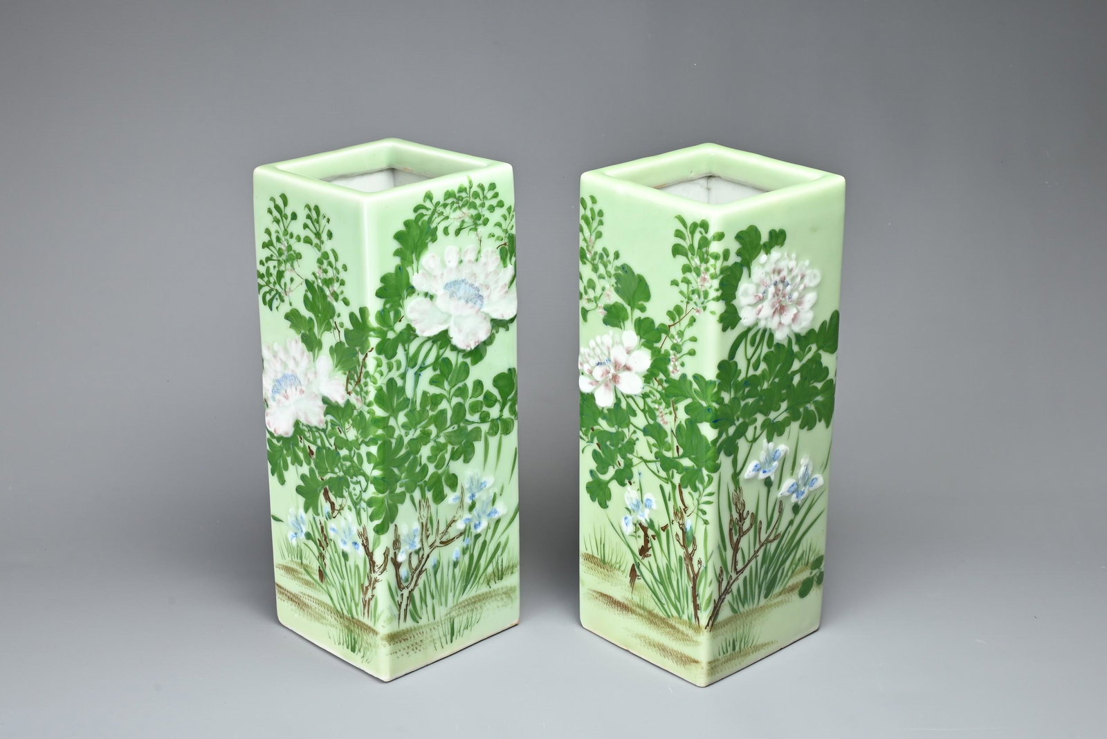 A PAIR OF VINTAGE JAPANESE SQUARE FORM VASES. Pale celadon ground with painted floral decoration.: A PAIR OF VINTAGE JAPANESE SQUARE FORM VASES. Pale celadon ground with painted floral decoration. Approx. 31cm tall.